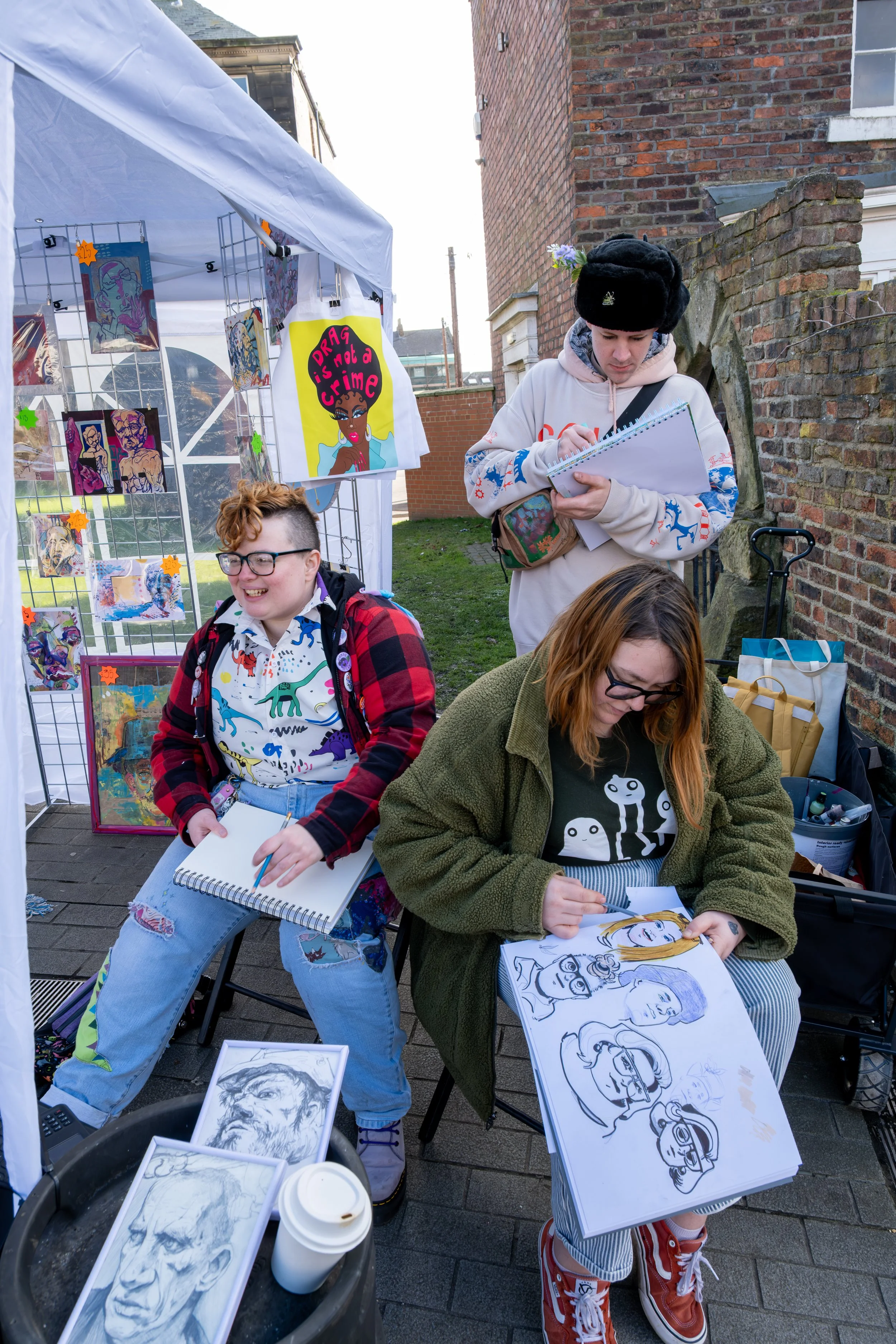 Local artists photographed at work during a Sunniside community arts event.