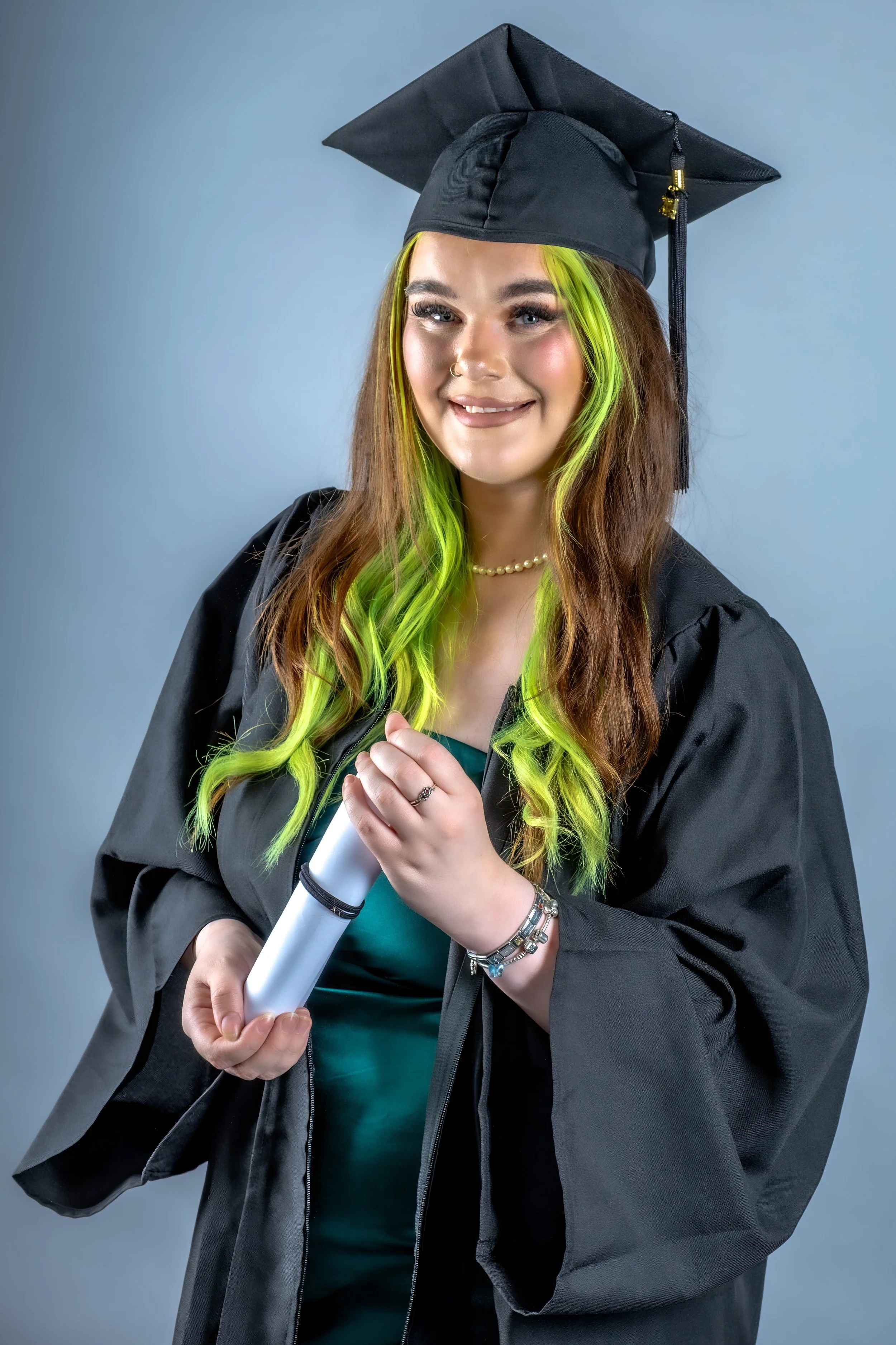 Graduation headshot of a young woman in University of Sunderland academic robes.