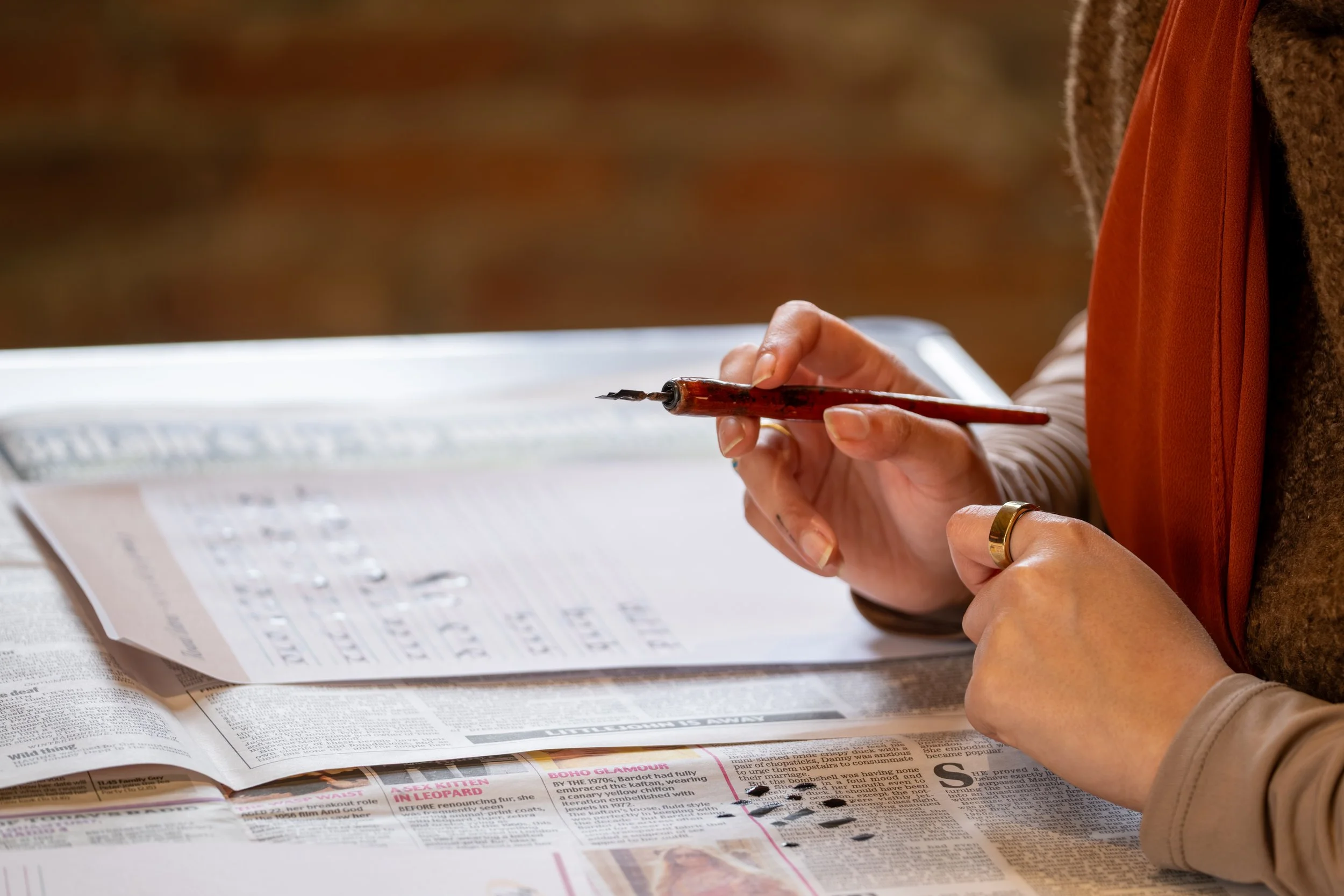 Participant working on calligraphy during a creative workshop at Hylton Castle, Sunderland.