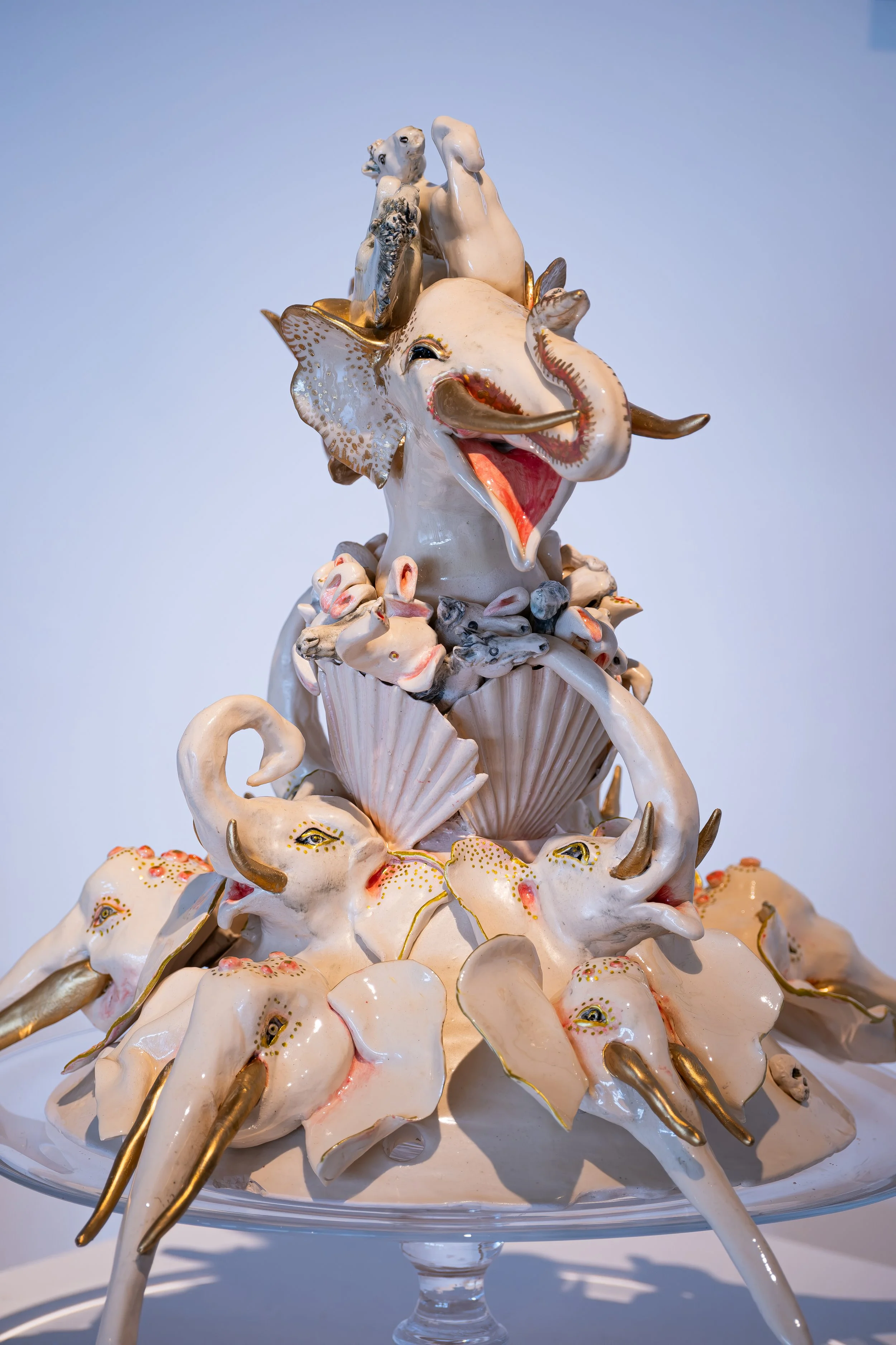 Artist with their ceramic work photographed during an exhibition at the National Glass Centre.