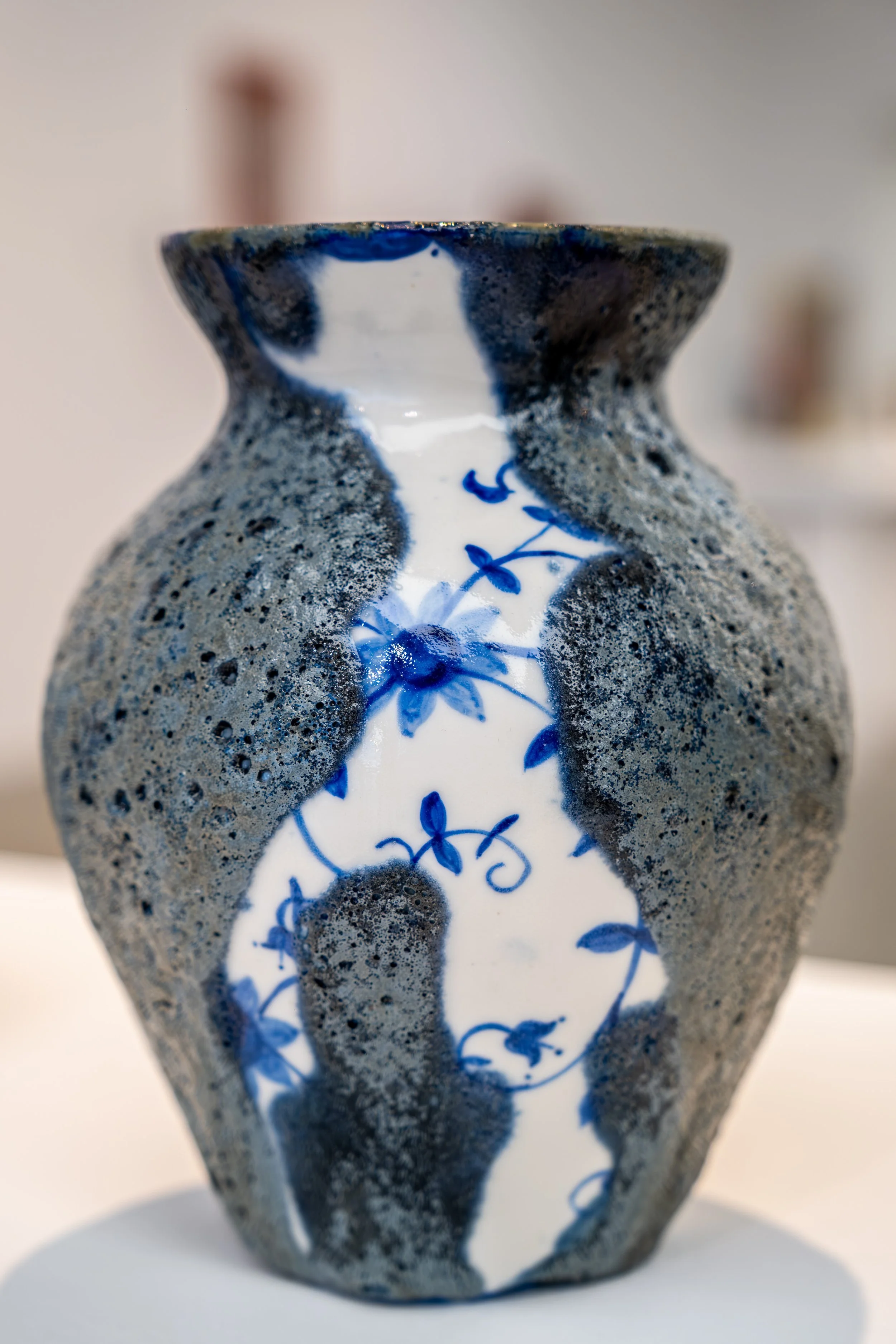 Ornate hand-painted ceramic jugs photographed with the artist at Sunderland’s National Glass Centre.