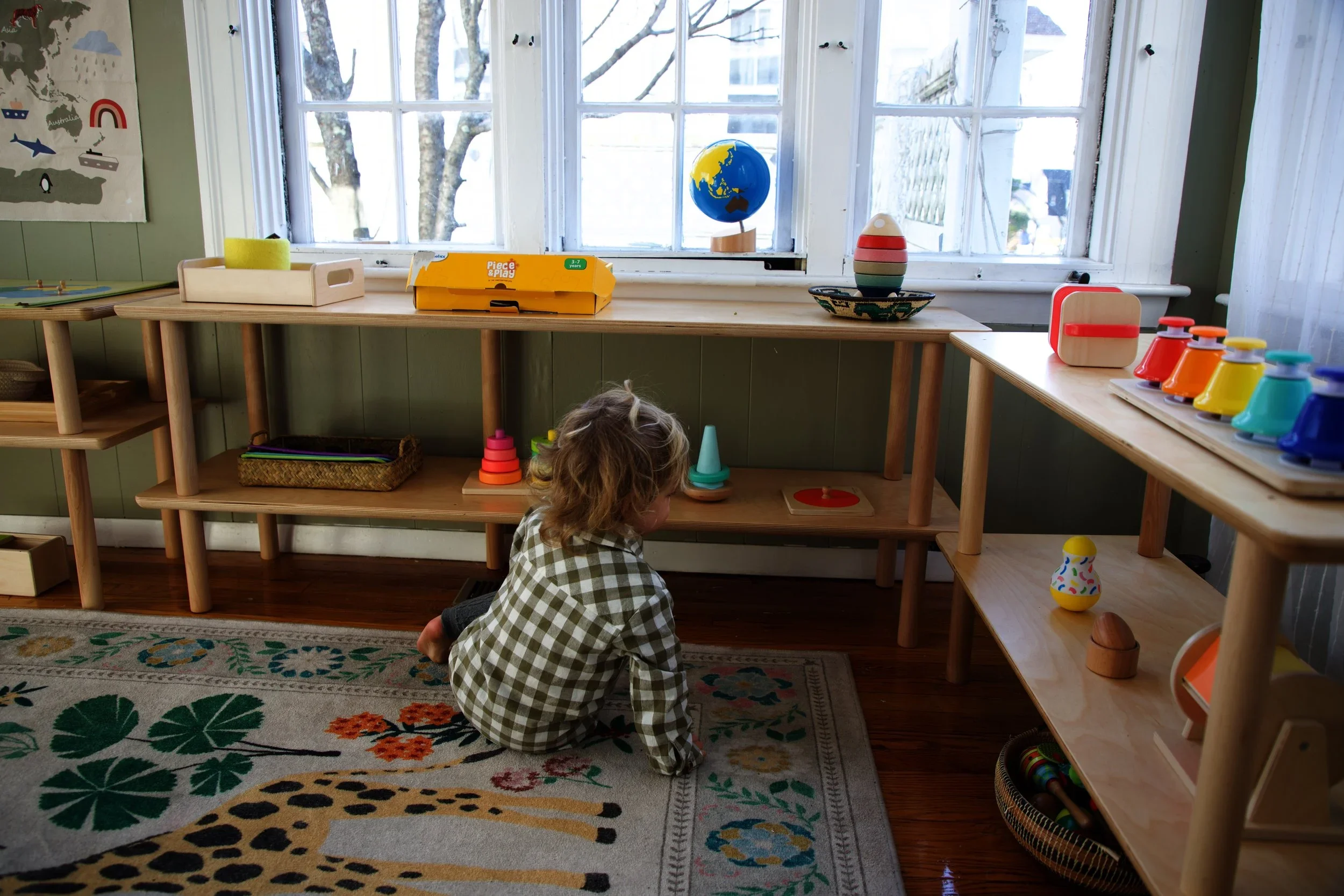 Little boy playing with montessori toys at home