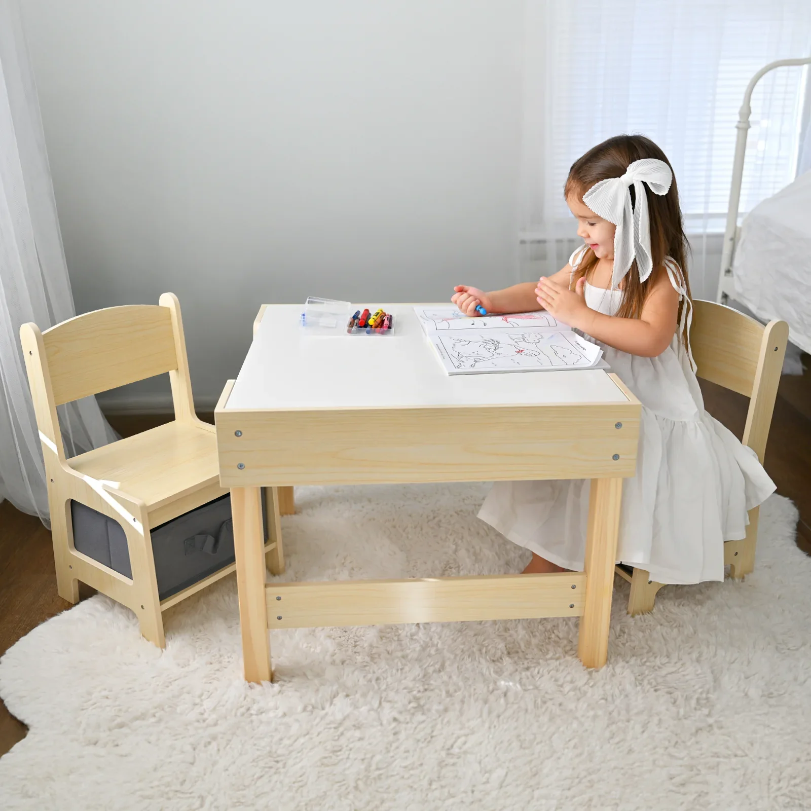 Child coloring on children's table and chair set