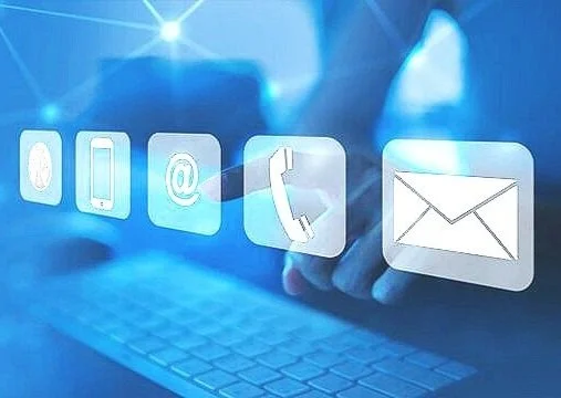 Projection of digital communication icons, including a phone, email, and messaging, over a computer keyboard.