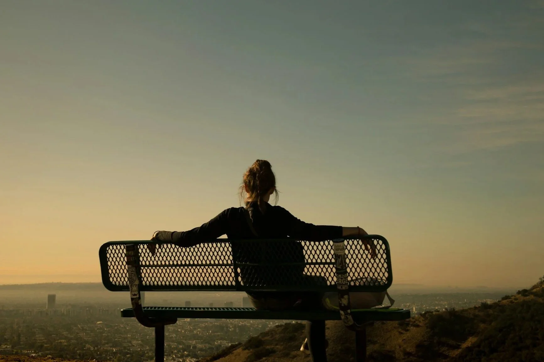 A woman resting on a bench symbolizing the peace that comes from trauma therapy in West Chester, PA.