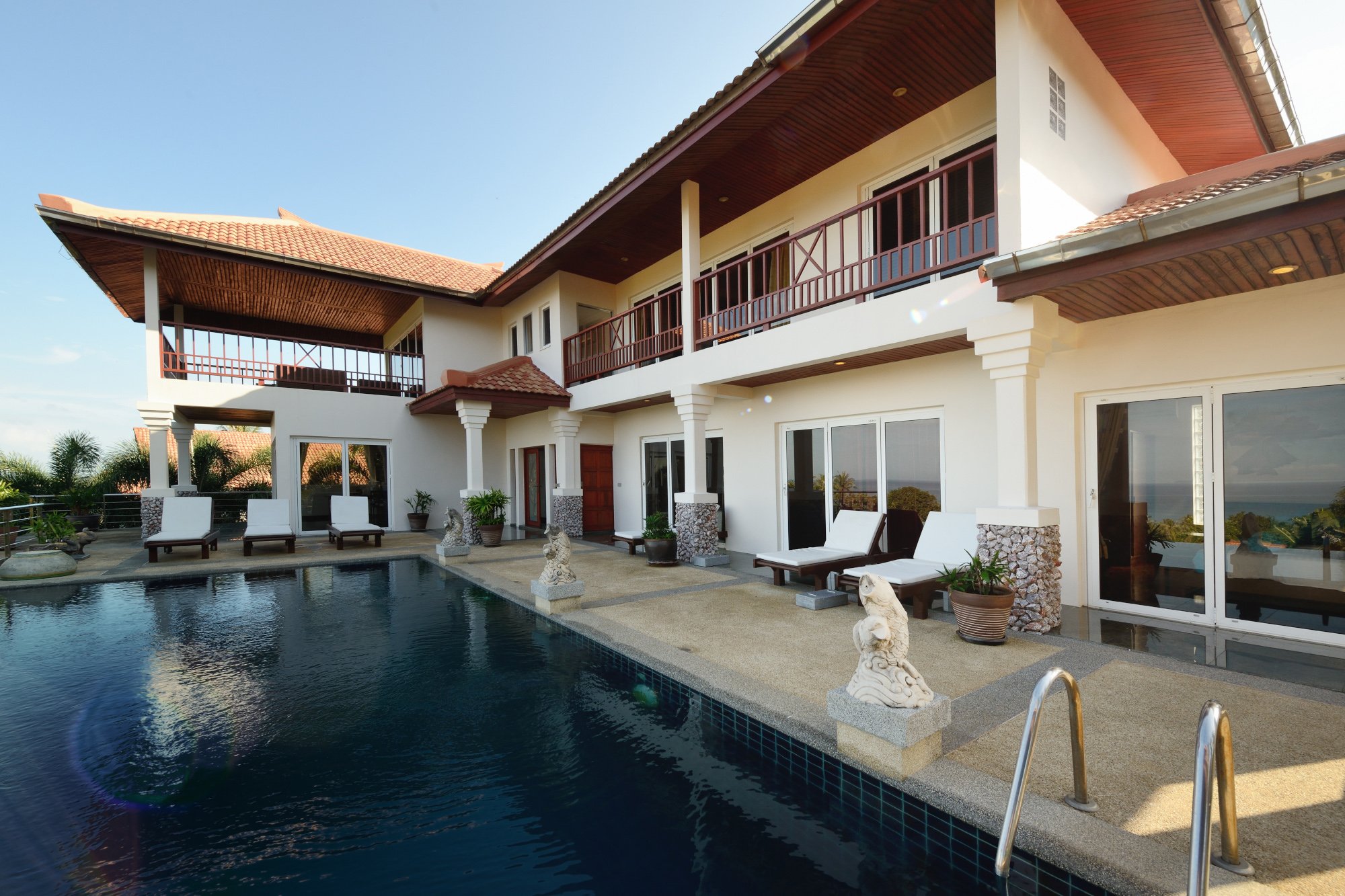 Outdoor views showcasing the architecture and pool area of a holiday property.