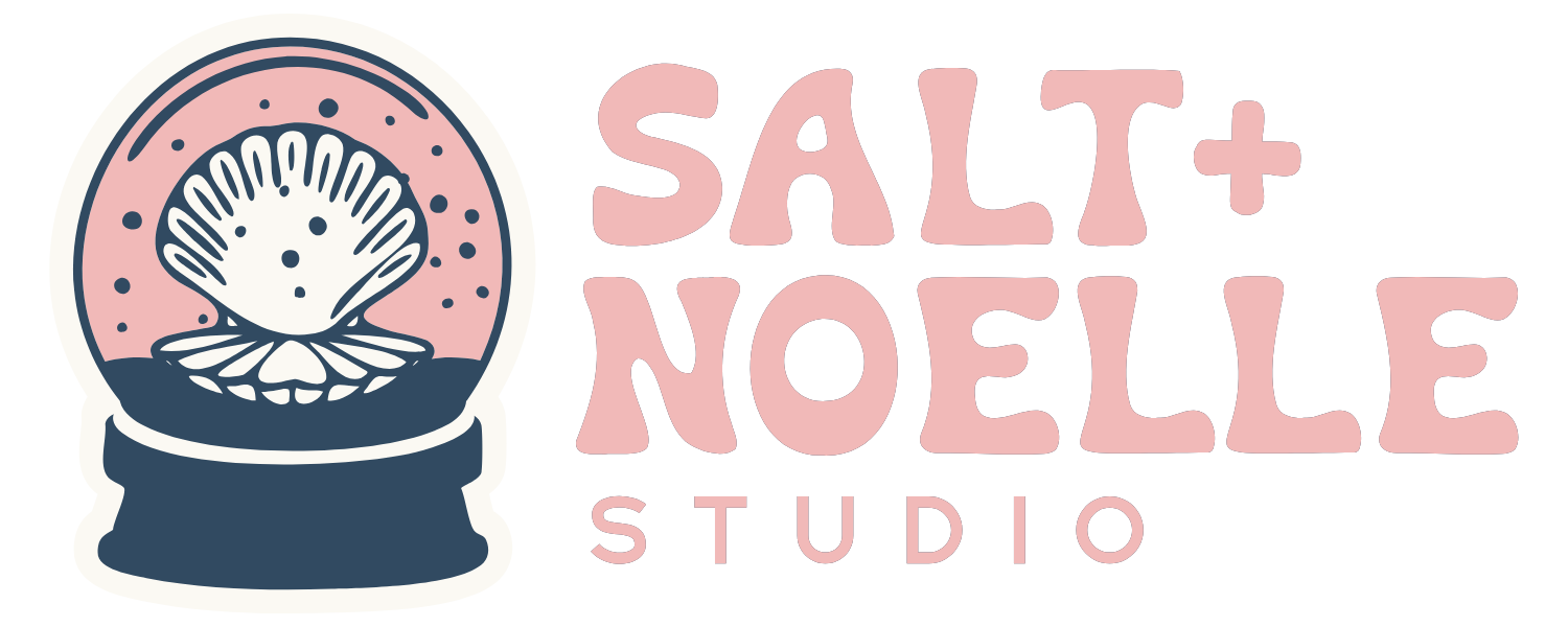 Logo for Salt + Noelle Studio featuring a stylized seashell inside a snow globe and the text 'Salt + Noelle Studio' in pink and navy blue.