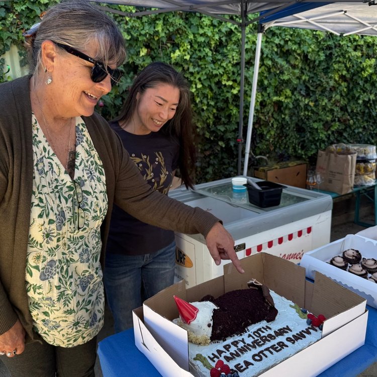 Sea Otter Savvy Executive Director Gena Bentall and Natsuko of Sea Otter Bakehouse with the custom cake for Sea Otter Savvy's 10th anniversary.