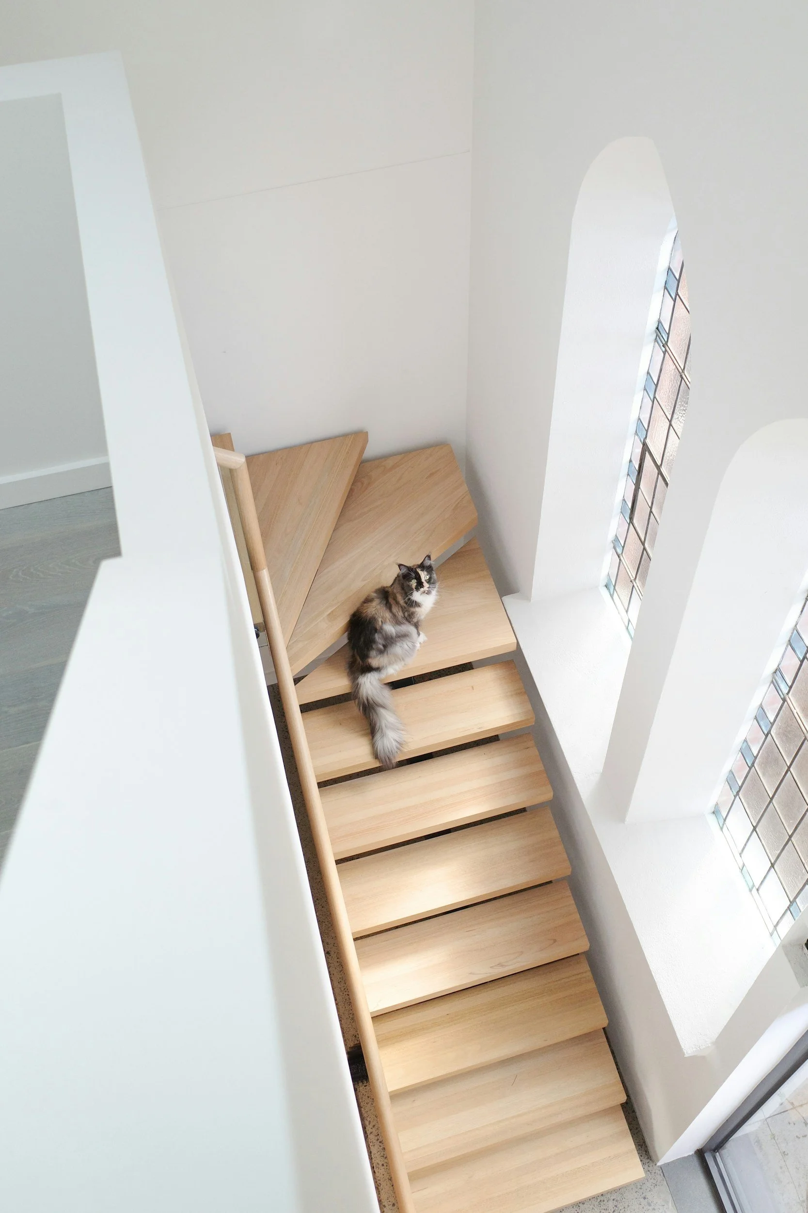 Energy-efficient home interior with timber staircase, symbolising sustainable residential design.