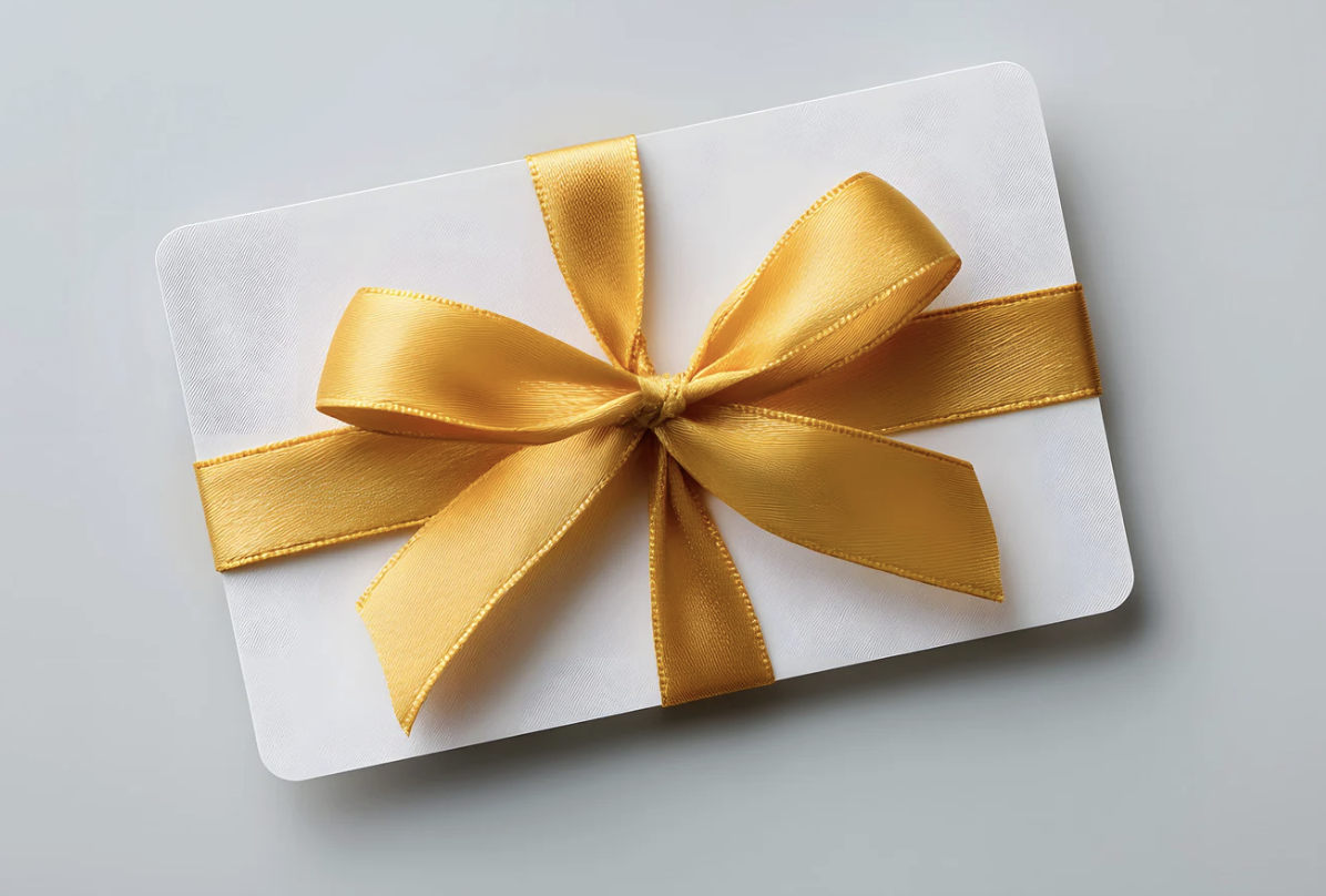 White envelope with a gold ribbon tied in a bow