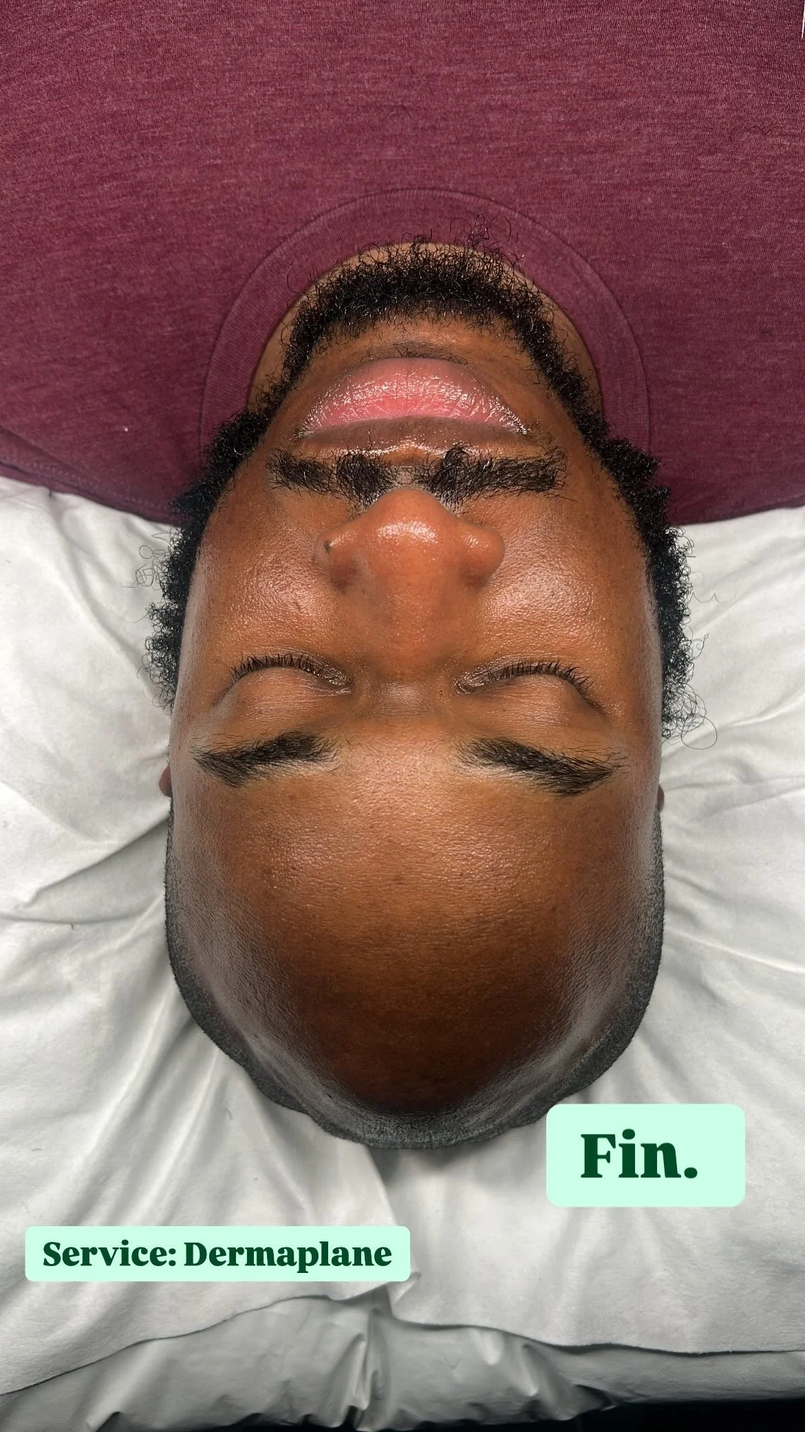 A man lying down with eyes closed, on a white background