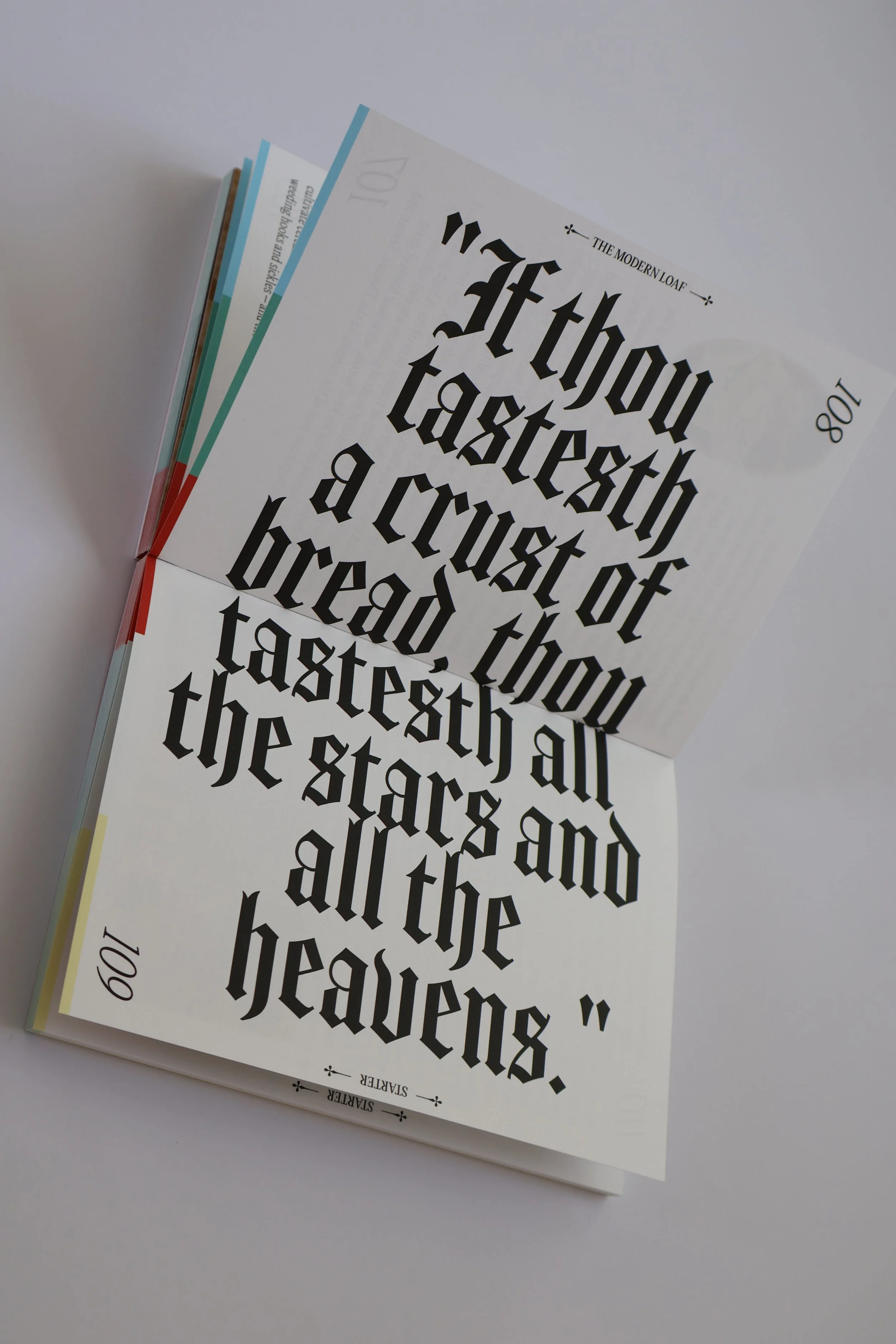 Close-up of a brochure with gothic blackletter font and the words "The Modern Loaf" at the top, partially visible, on a white background.