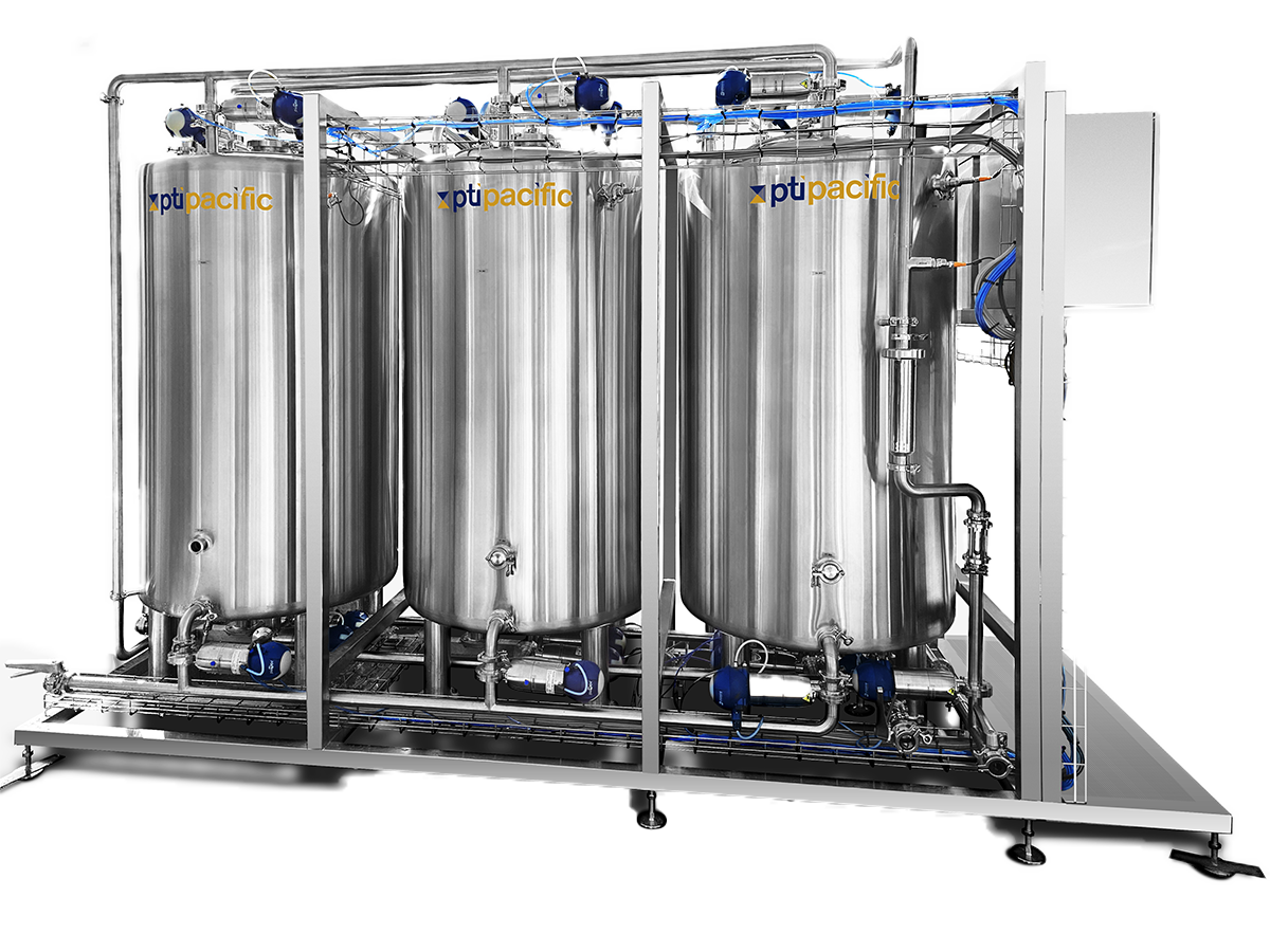 Industrial water filtration system with three large stainless steel tanks labeled PTI Pacific, connected by pipes and pumps.