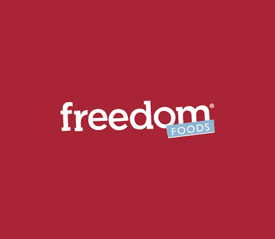 Logo of Freedom Foods on a red background, featuring the word 'freedom' in white lowercase letters and a blue banner with the word 'FOODS' in white letters.