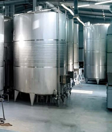 Large silver industrial storage tanks in a factory setting