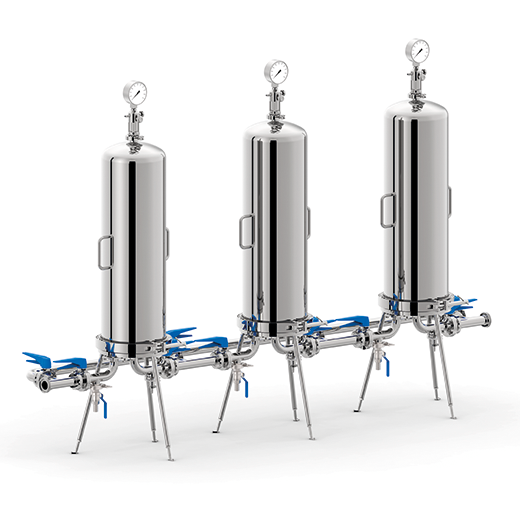 Three industrial stainless steel autoclaves with pressure gauges and blue valves connected by pipes on metal legs.