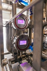 Industrial equipment with digital gauges and stainless steel pipes