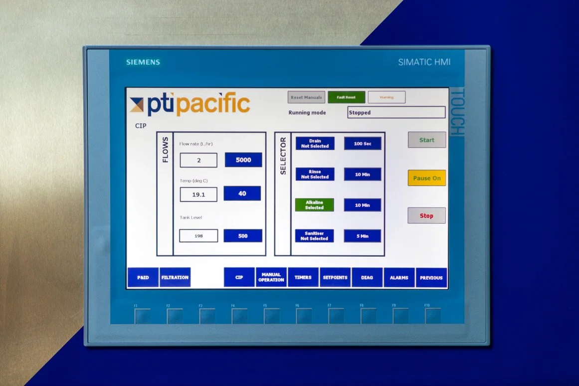Siemens SIMATIC HMI control panel displaying PTI Pacific system interface with flow rates, temperature, tank level, and operation controls.