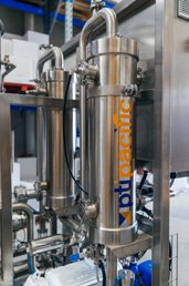 Stainless steel industrial equipment with PTU Pacific logo