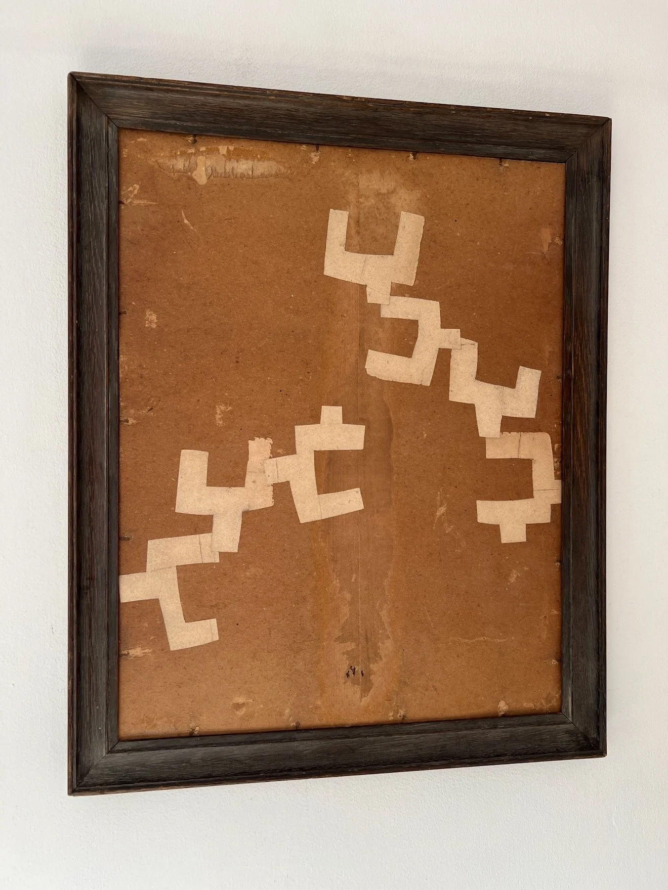 Seven by Lucy Naughton. A naive collage artwork on found board in a vintage frame