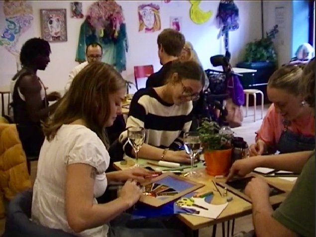 Friends drawing together with a glass of wine.