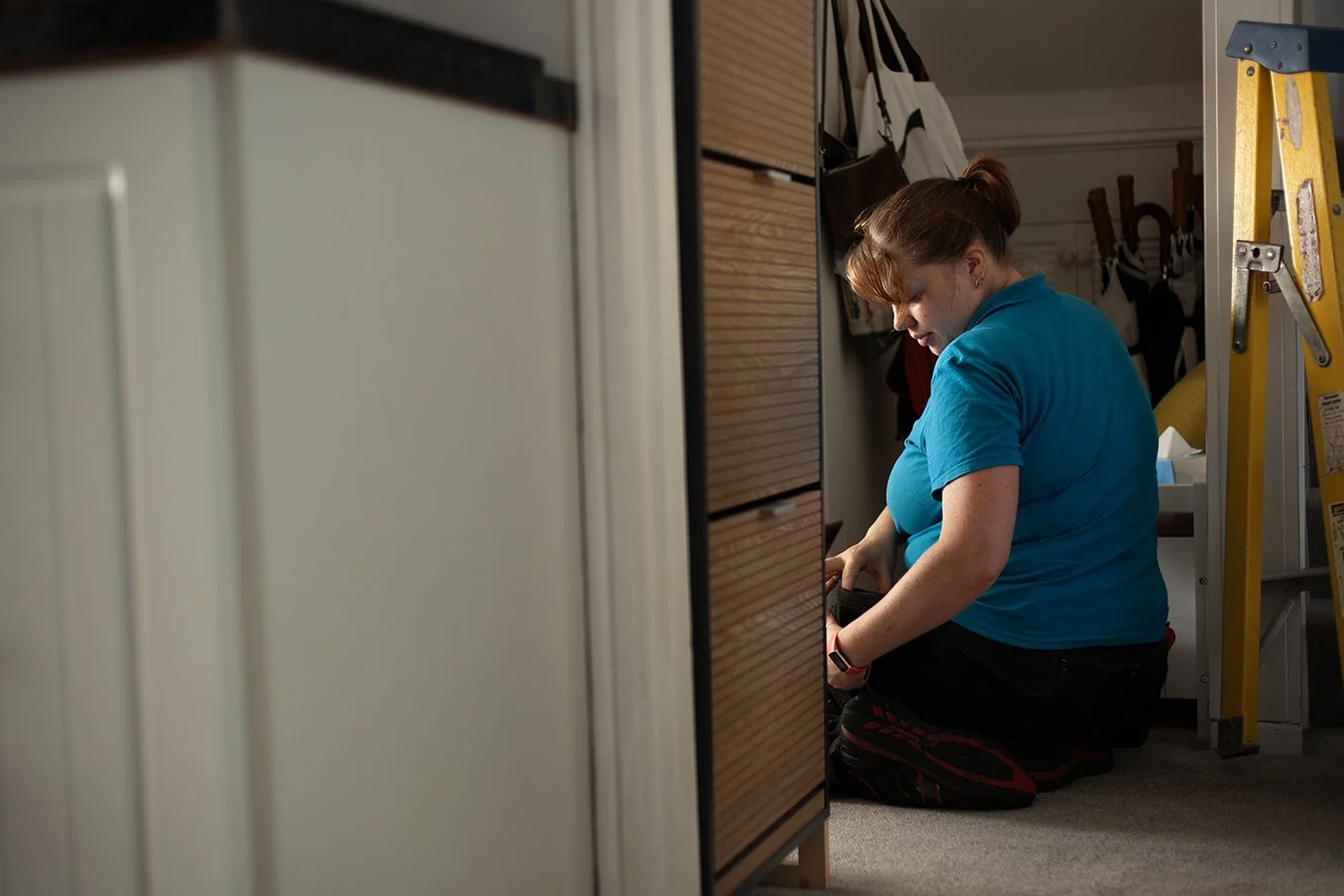 Checkatrade work. Anne, an electrician, at work at a domestic property. Epsom, Surrey. 2025.