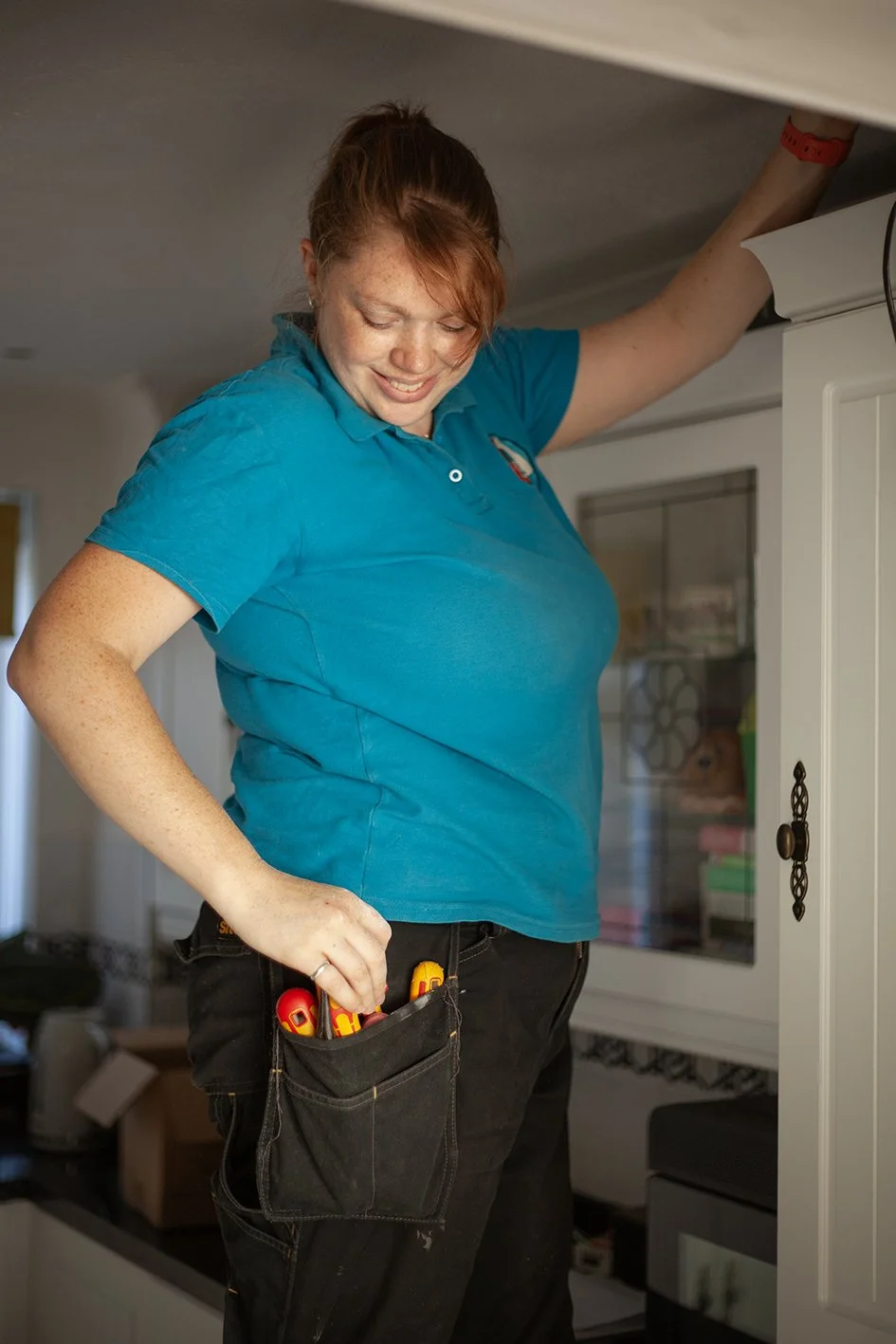 Checkatrade work. Anne, an electrician, at work at a domestic property. Epsom, Surrey. 2025.