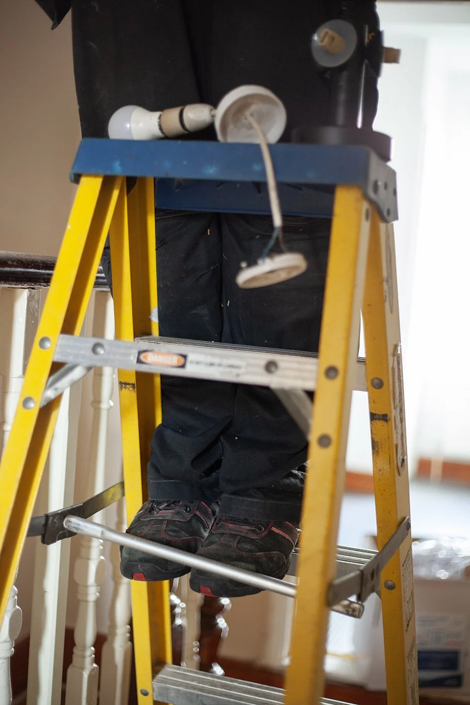 Checkatrade work. Anne, an electrician, at work at a domestic property. Wimbledon. 2025.