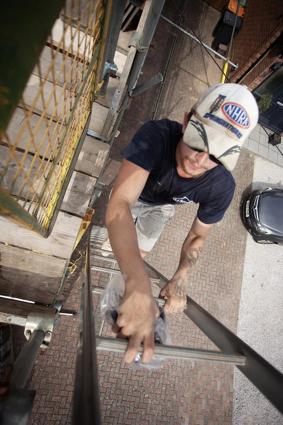 Checkatrade work. The team from G J Smith Roofing at work in Dunstable. Climbing the ladder to the roof. Bedfordshire. 2025.