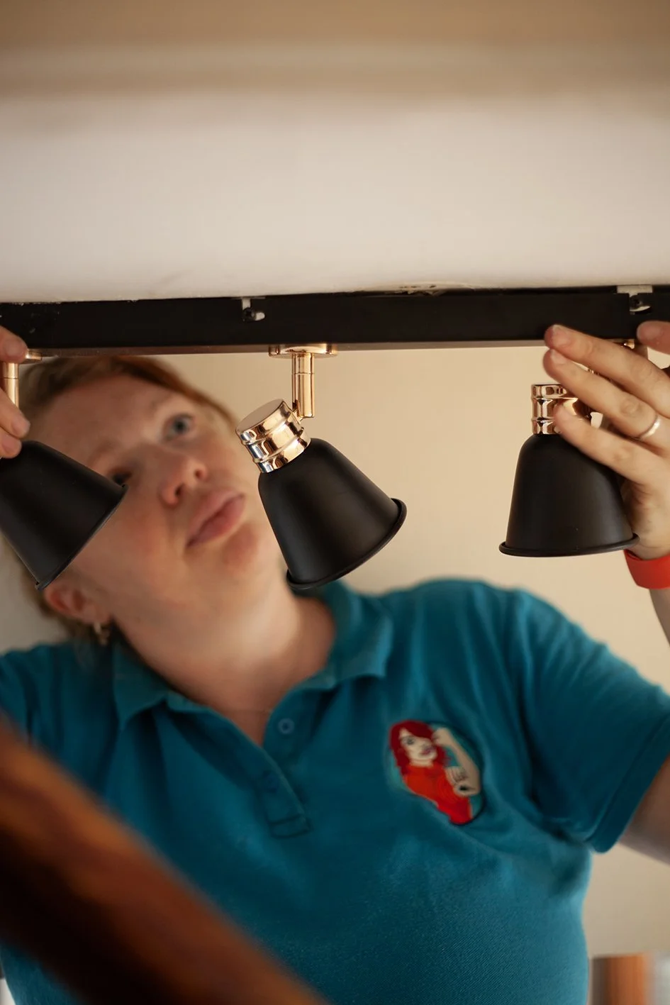 Checkatrade work. Anne, an electrician, at work at a domestic property. Wimbledon. 2025.