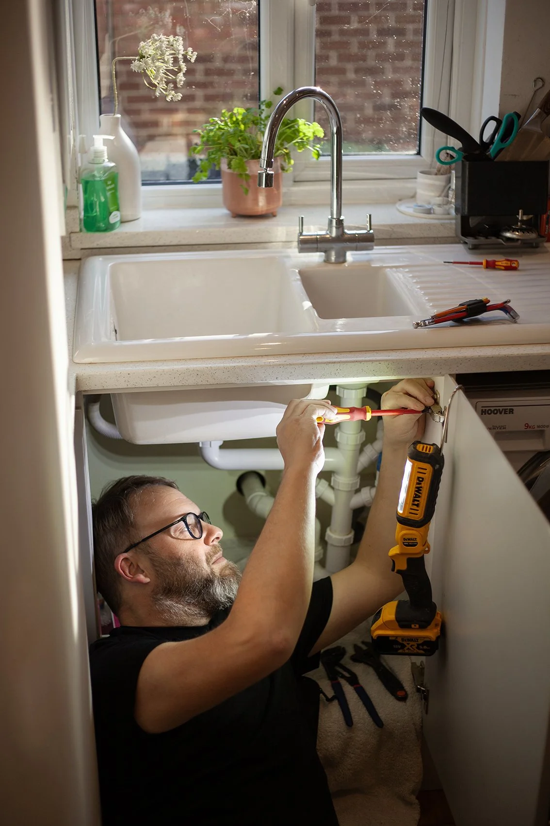 Aaron from AW Plumbing and Heating. At work under a sink. Checkatrade work. Canterbury, UK. 2025