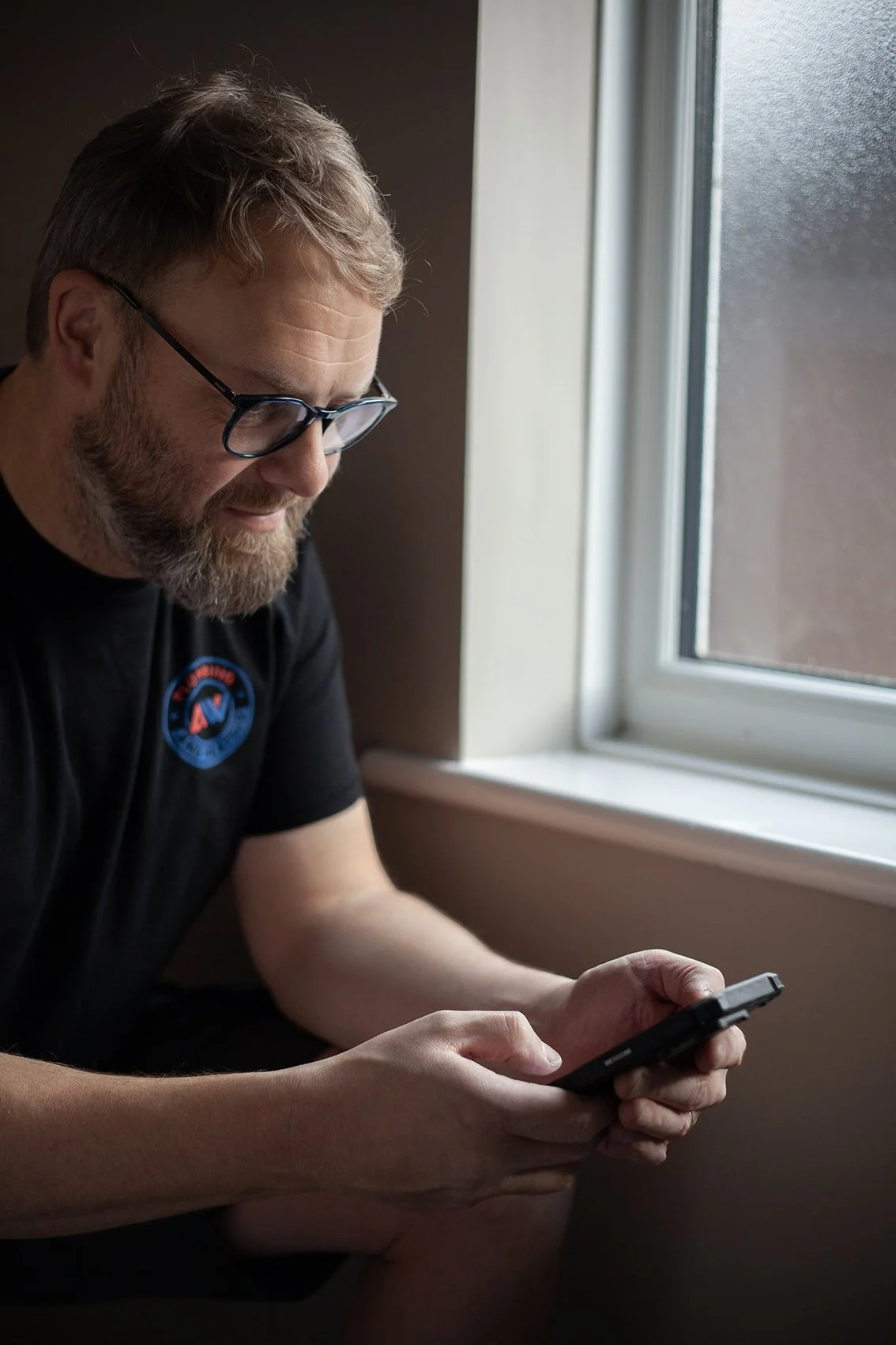 Aaron from AW Plumbing and Heating. At work messaging a customer. Checkatrade work. Canterbury, UK. 2025