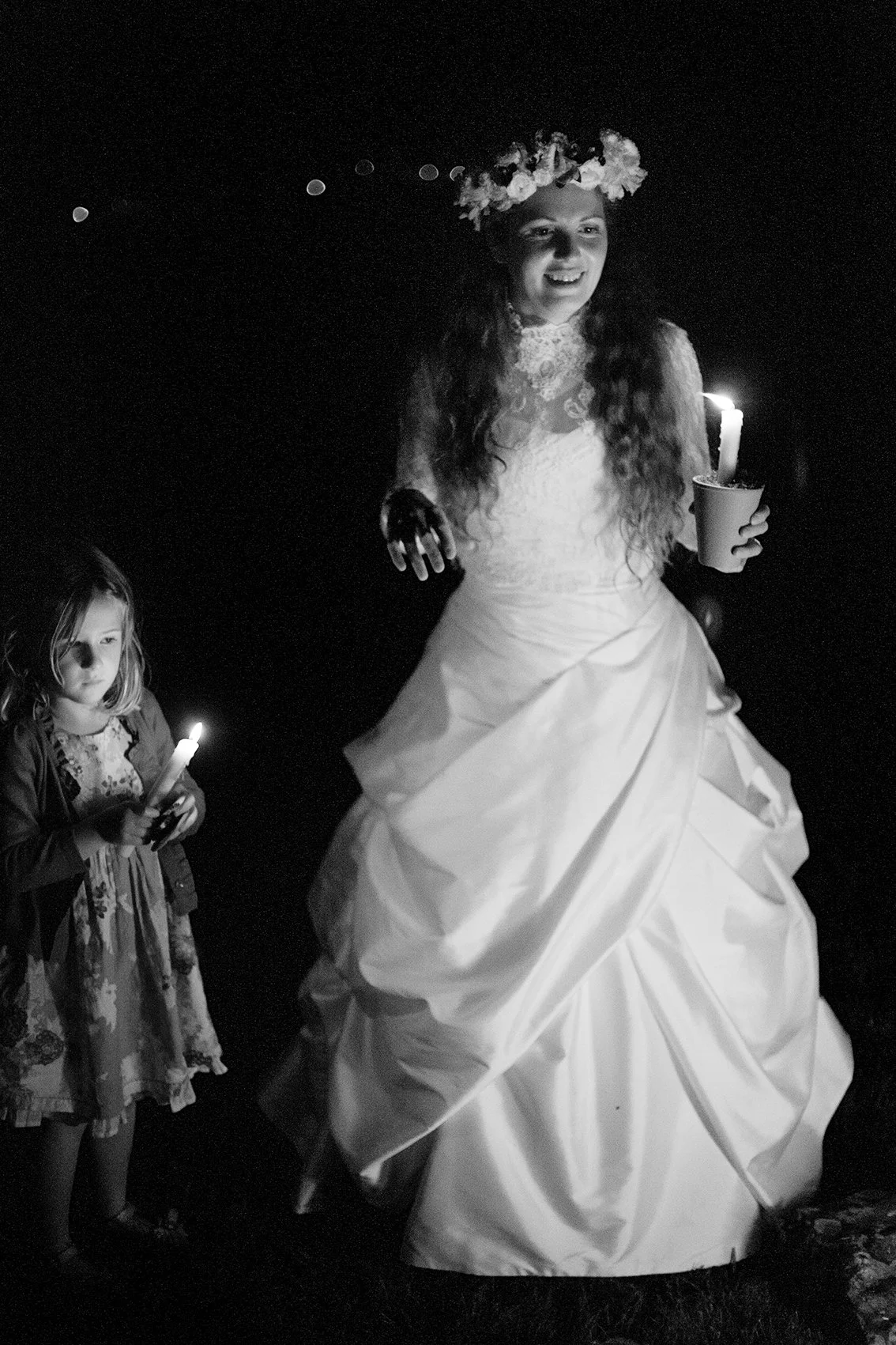 Zoe and Seth's wedding. Chew Stoke, UK. The bride by the fire after the reception.