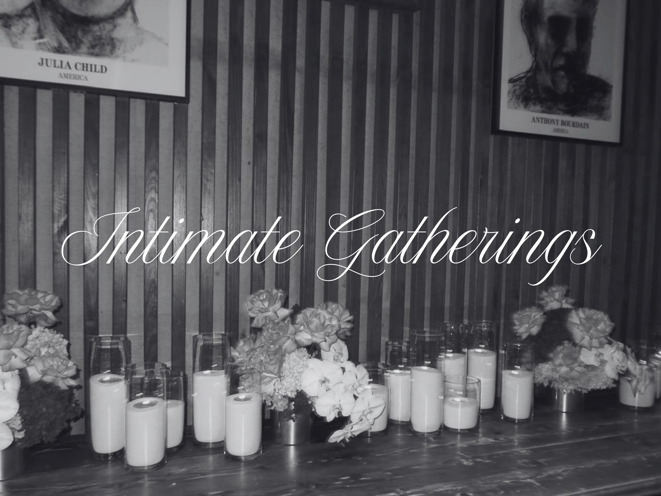 A memorial display with candles and white flowers in front, a striped wood wall in the background, and framed black-and-white portraits of Julia Child and Anthony Bourdain. The text "Intimate Gatherings" is overlaid on the image.