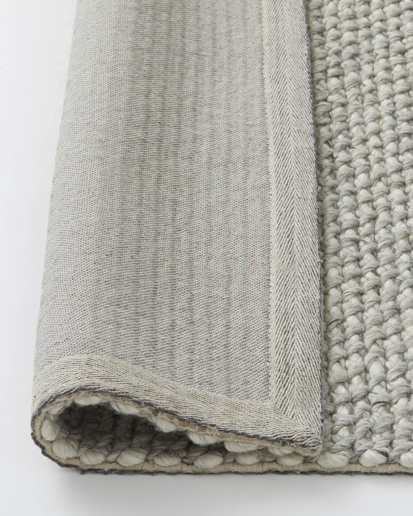 recdgulWF7KVIhjbn_Emerson_Rug_Feather_Backing.webp