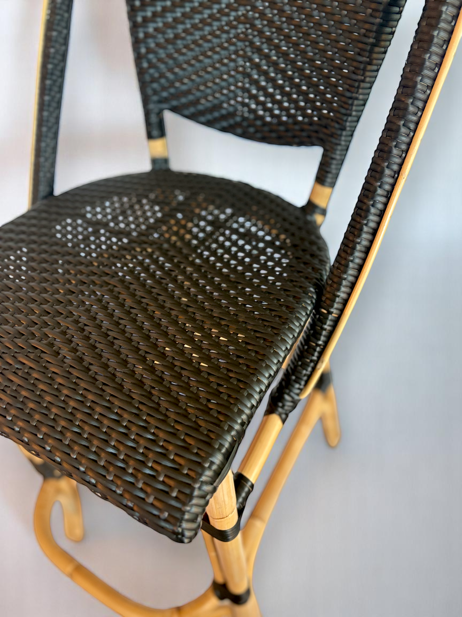 Pre-owned, Sofie Bar Stool by Sika Design, featuring a natural rattan frame with black woven seat and back.