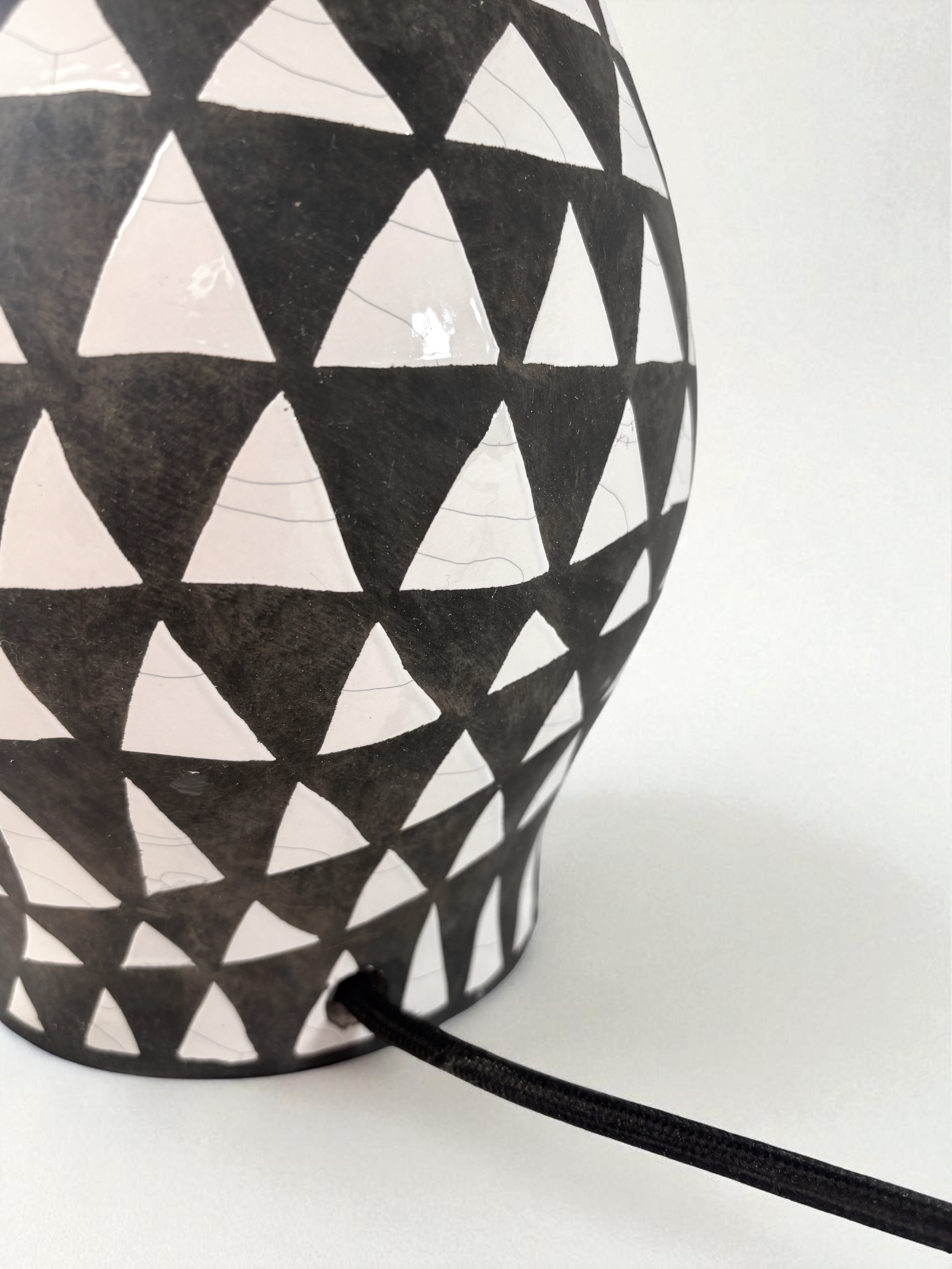 Image of two, pre-owned, black and white earthenware table lamps with jute lampshades.