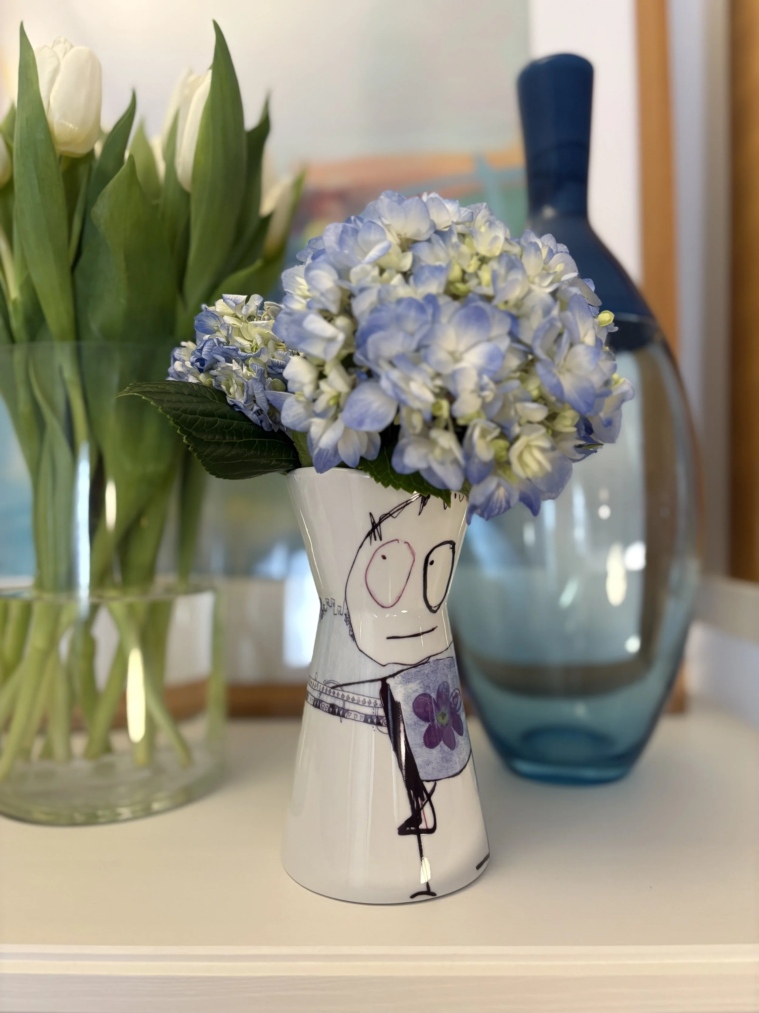Poul Pava 'Be Friends' porcelain pitcher by Aida, with cheerful illustrated face and purple flower on white ceramic.