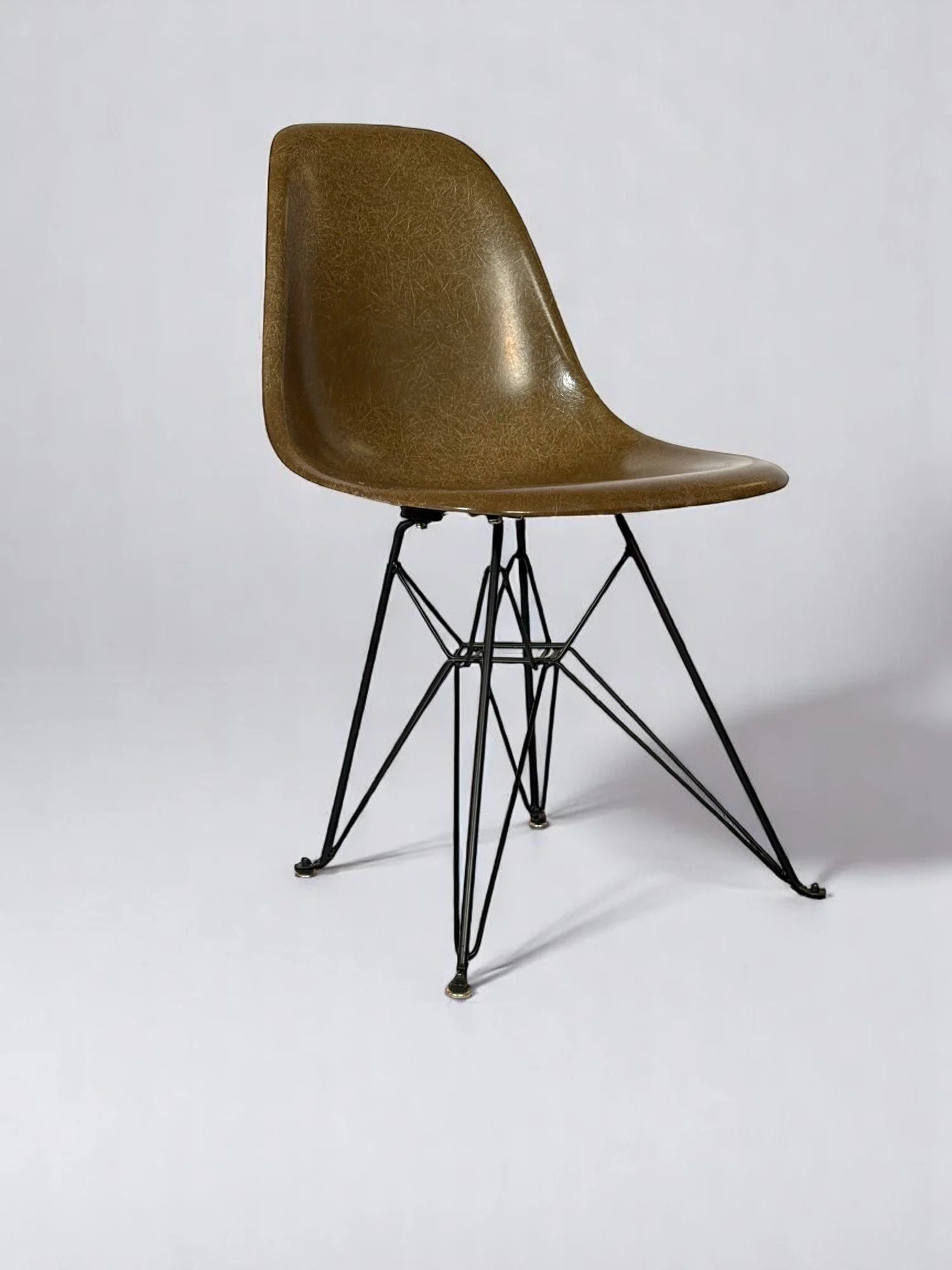 Pre-owned, Modernica Case Study Furniture Side Shell Eiffel chairs in color pumpernickel with black metal base.