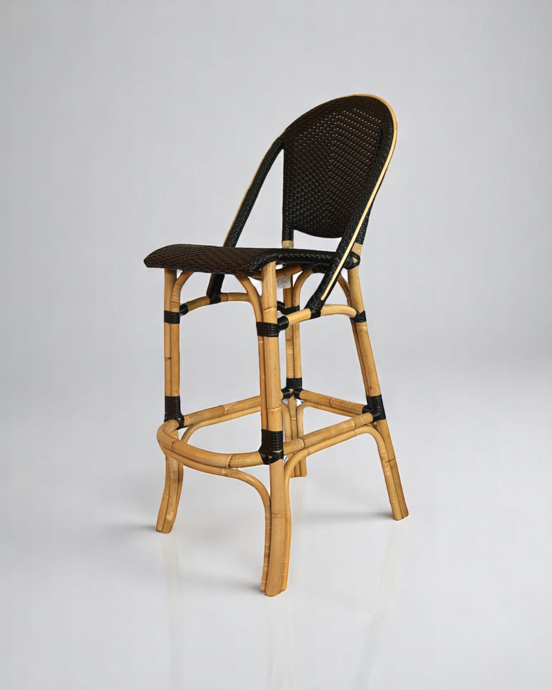 Pre-owned, Sofie Bar Stool by Sika Design, featuring a natural rattan frame with black woven seat and back.