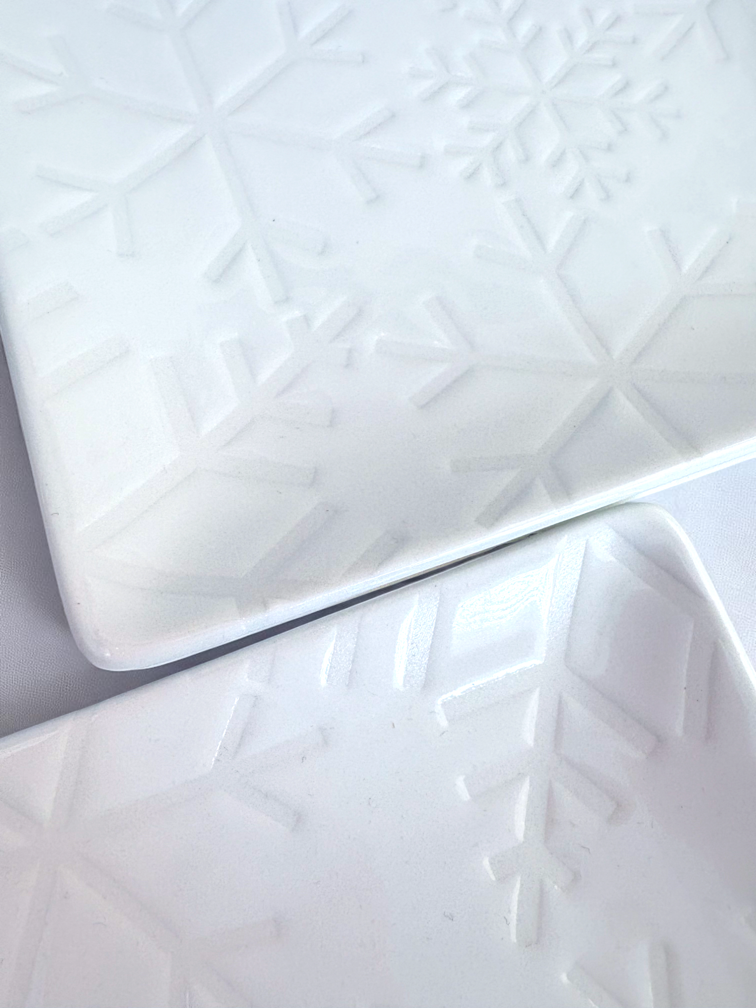 Set of 4 white snowflake embossed plates by Crate & Barrel, pre-owned.