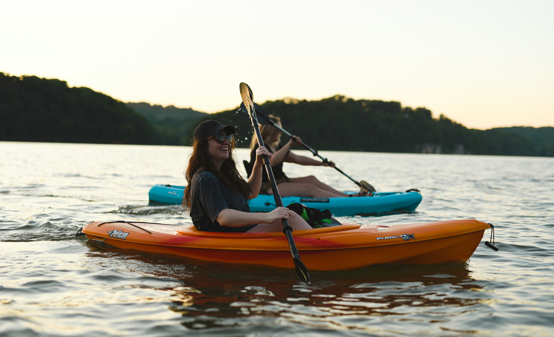 Two colleagues on kayaks during a team building retreat