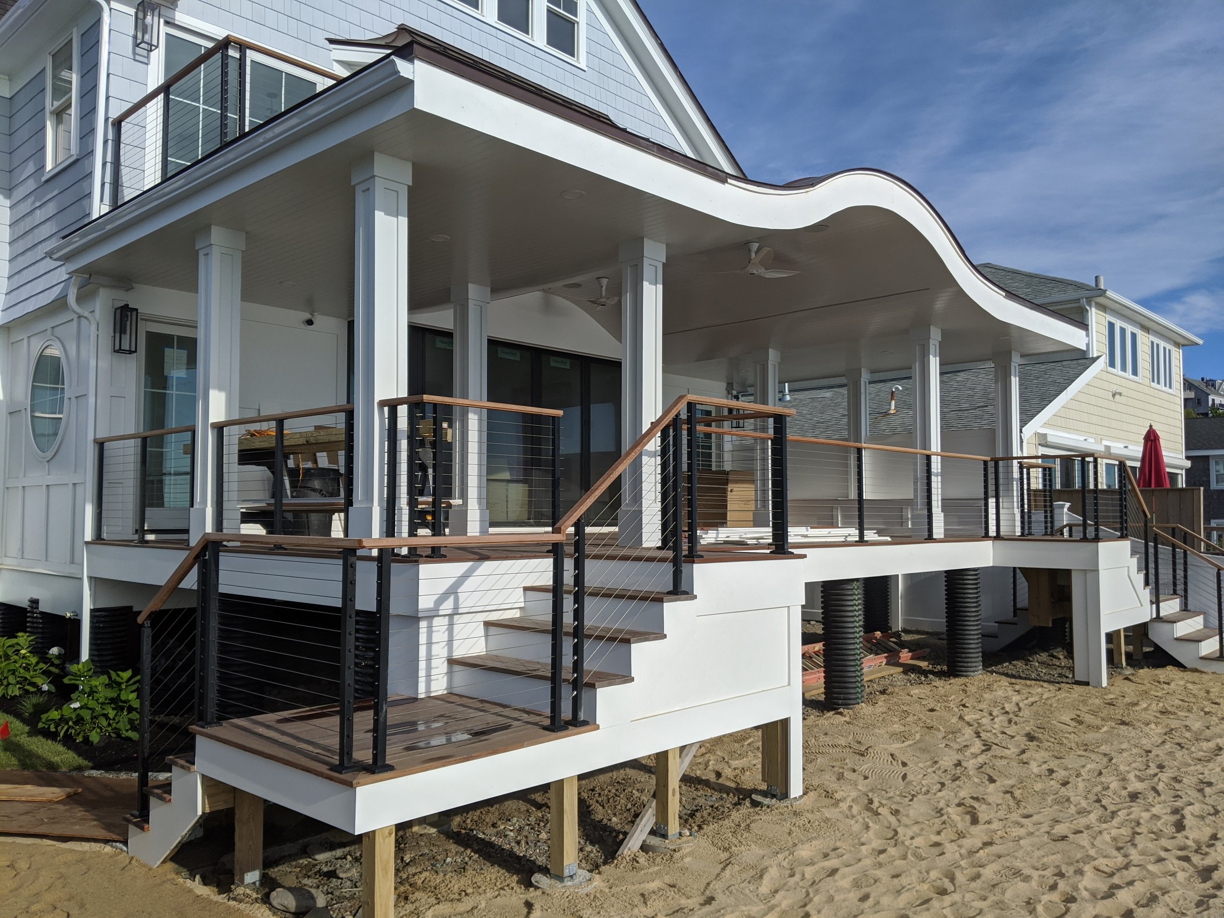 Modern beach house with raised deck and white exterior