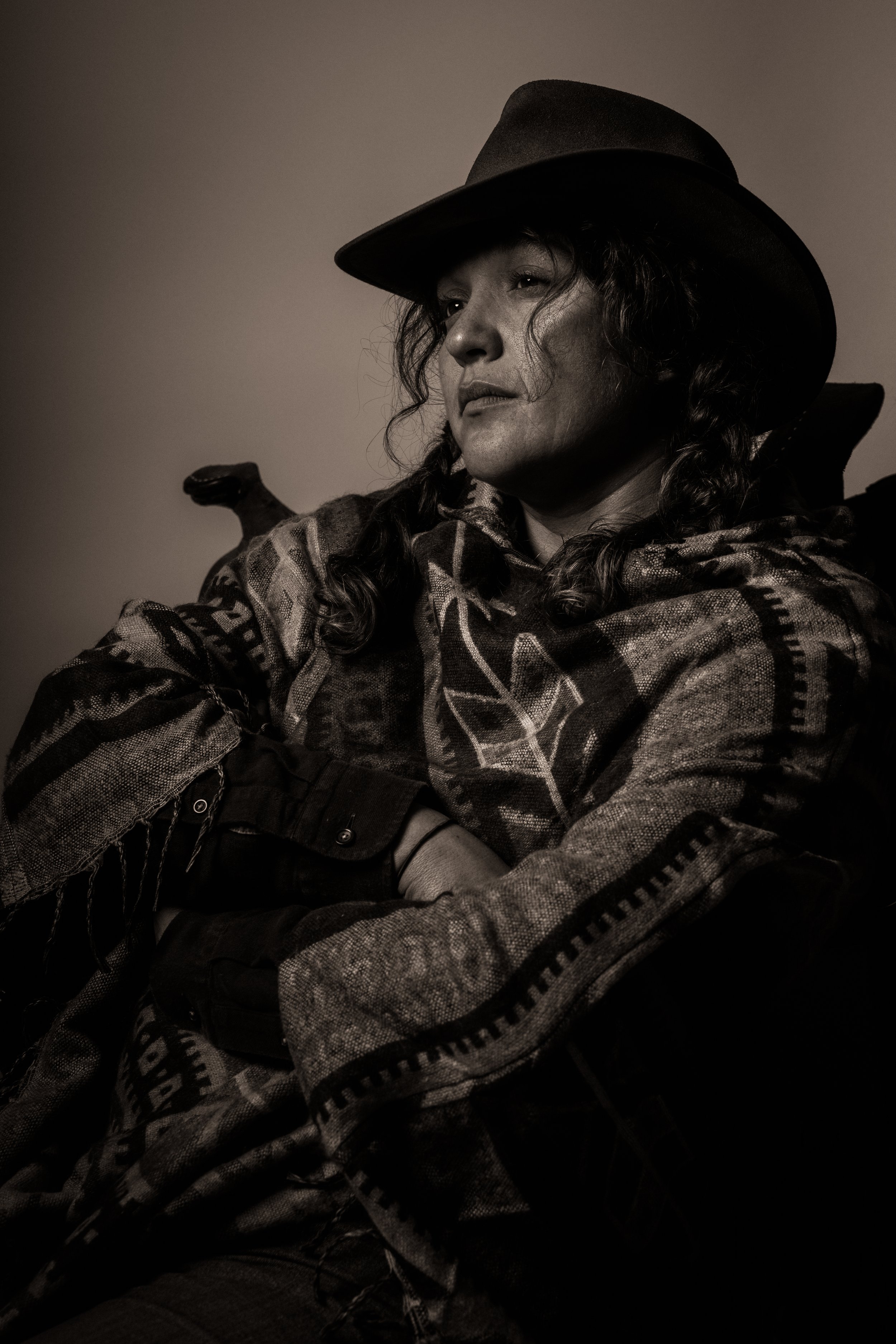 Black and white portrait of a woman wearing a hat and textured clothing