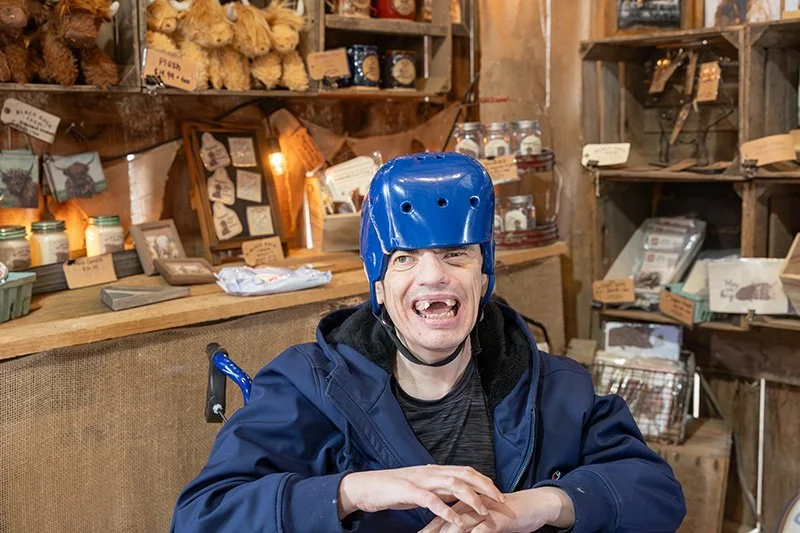 man in wheelchair and blue helmet