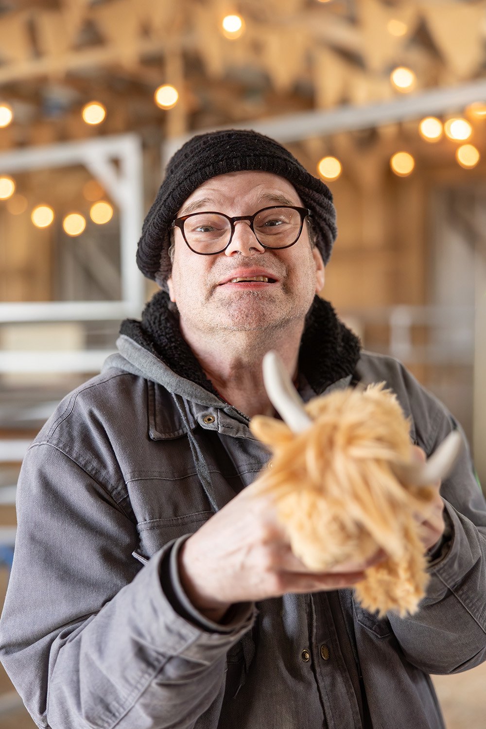 man holding stuffed cow