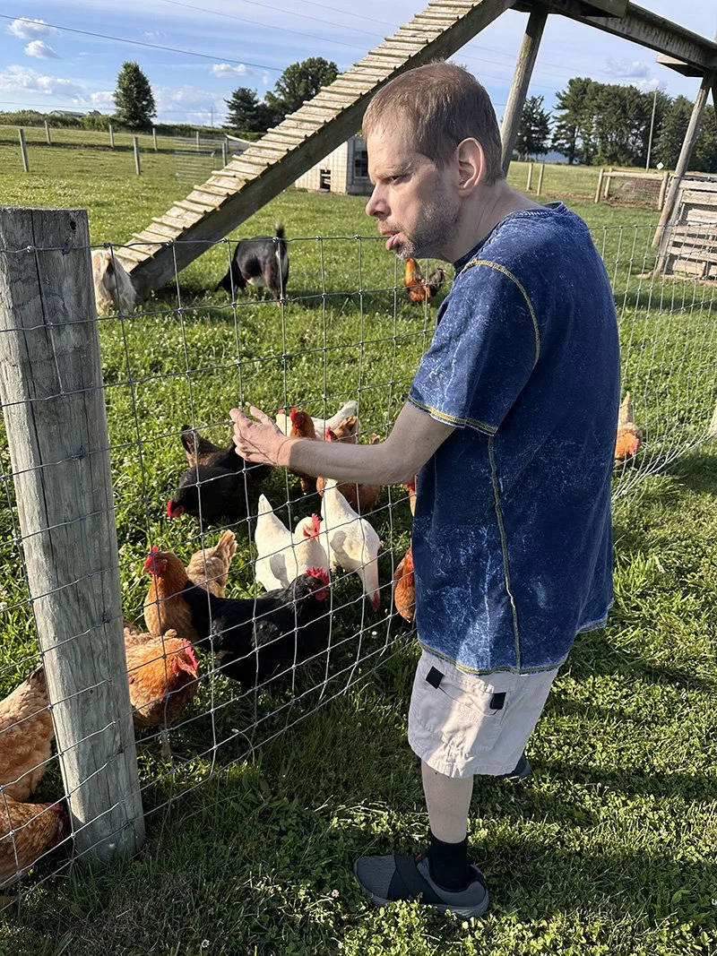 man at farm tour with chickens