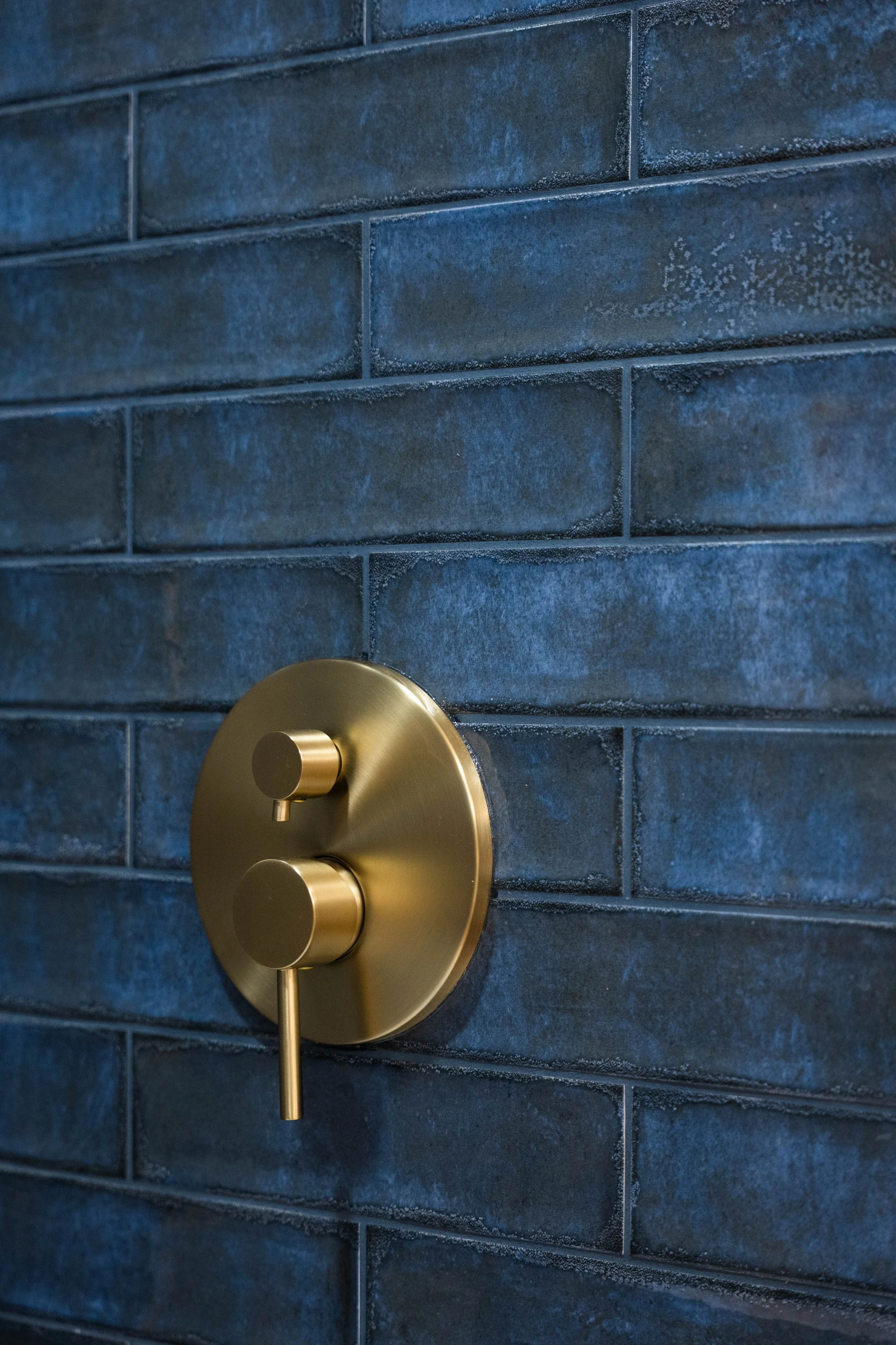 Detailed shot of updated bathroom tilework and finishes completed by a Phoenix construction team