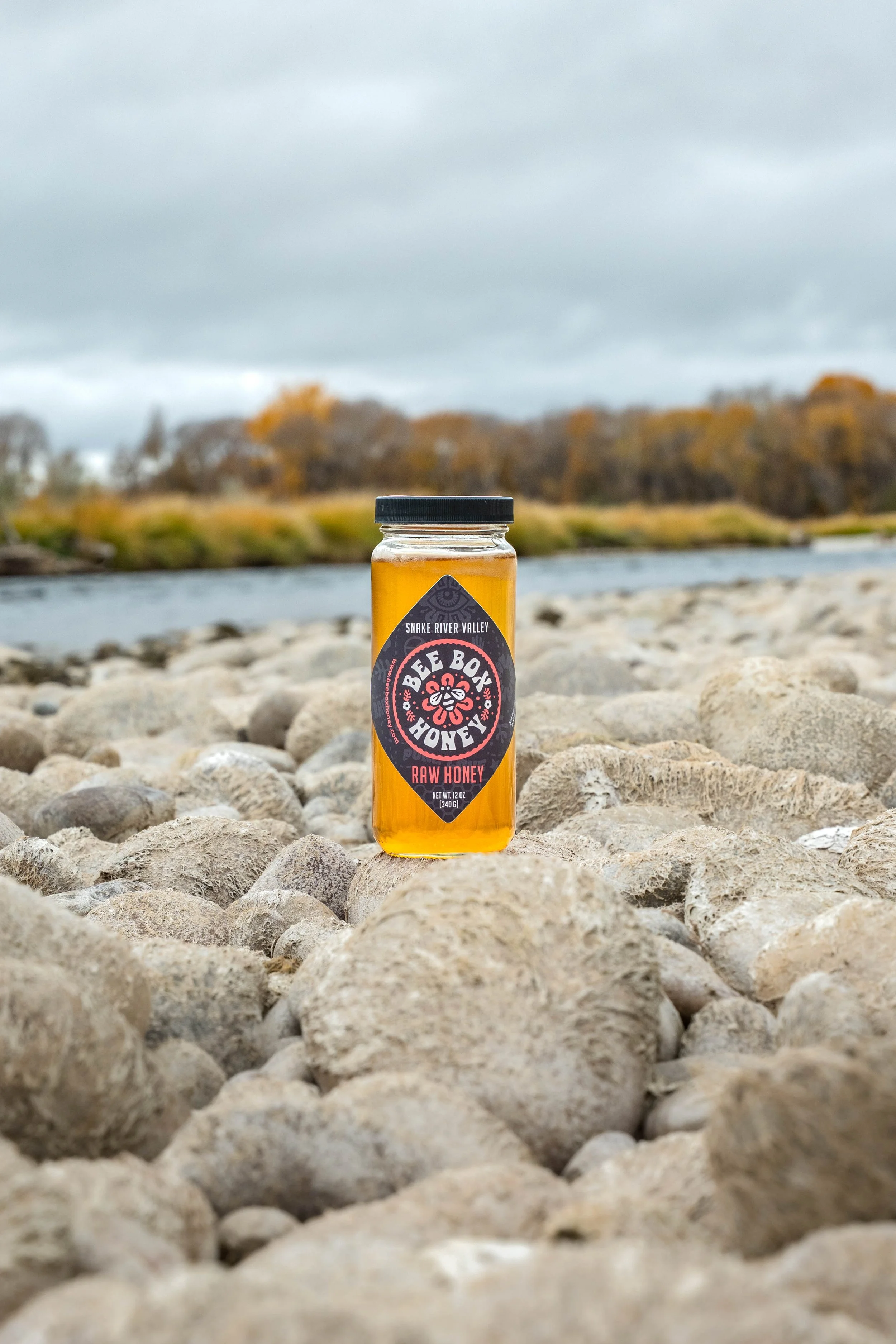 Product photography showcasing artisanal honey packaging with warm tones and a nature-inspired aesthetic