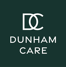 dark green background with white overlay writing showing a letter D and C together with the words Dunham Care underneath.
